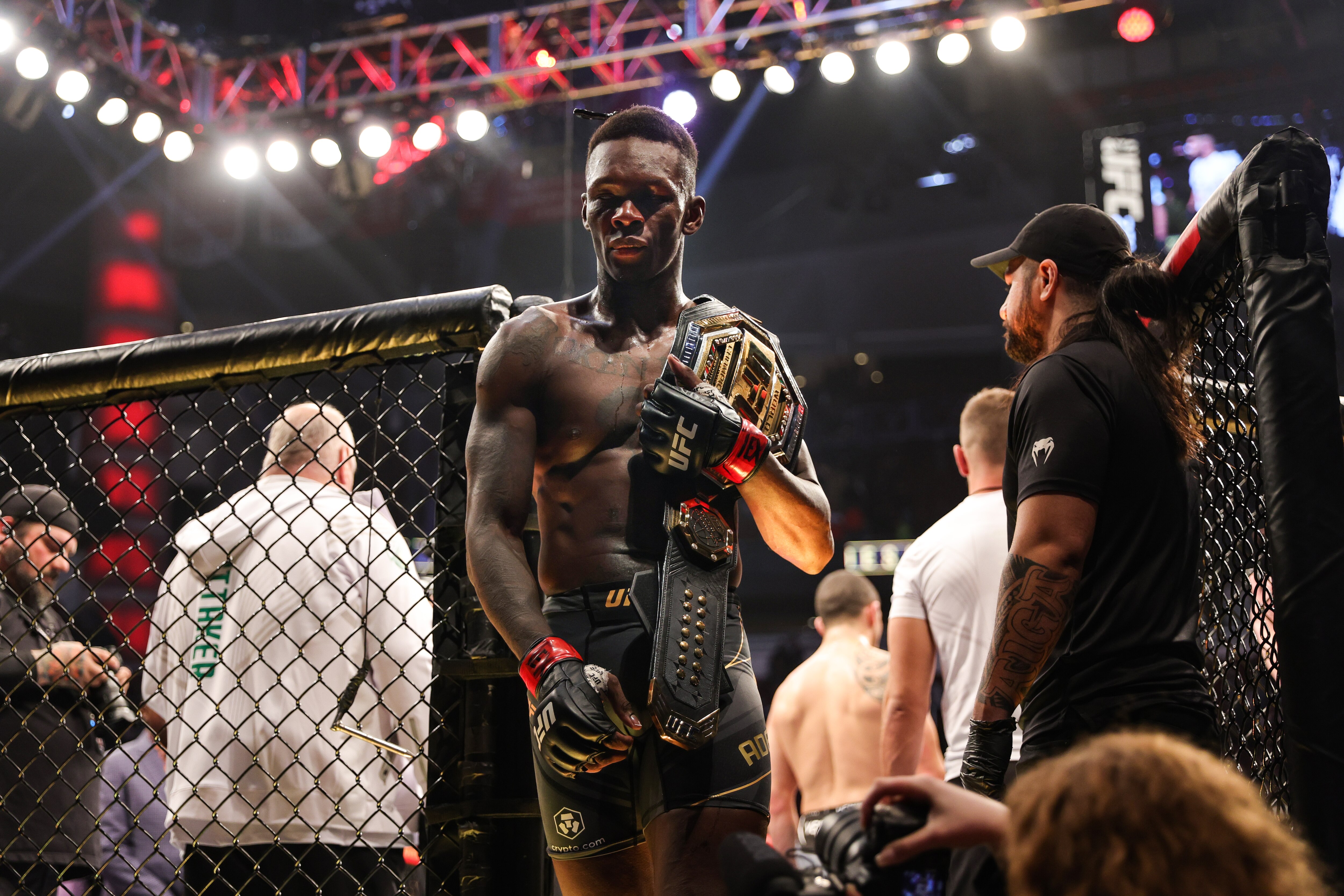HOUSTON, TEXAS - FEBRUARY 12: Israel Adesanya of Nigeria celebrates after defending his middleweight championship against Robert Whittaker of Australia during UFC 271 at Toyota Center on February 12, 2022 in Houston, Texas. (Photo by Carmen Mandato/Getty Images)