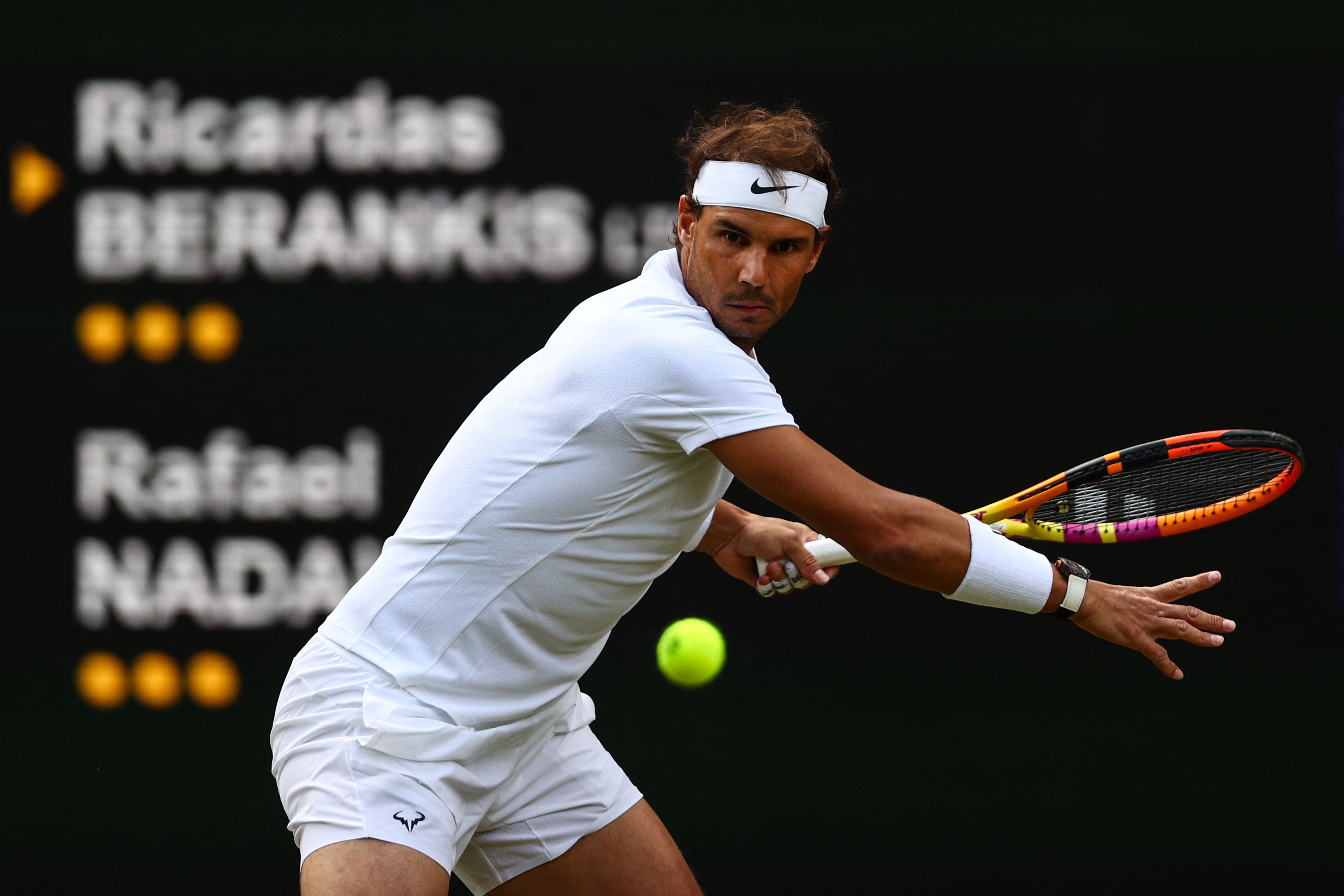 Spain's Rafael Nadal returns the ball to Lithuania's Ricardas Berankis during their men's singles tennis match on the fourth day of the 2022 Wimbledon Championships at The All England Tennis Club in Wimbledon, southwest London, on June 30, 2022. - RESTRICTED TO EDITORIAL USE (Photo by Adrian DENNIS / AFP) / RESTRICTED TO EDITORIAL USE (Photo by ADRIAN DENNIS/AFP via Getty Images)