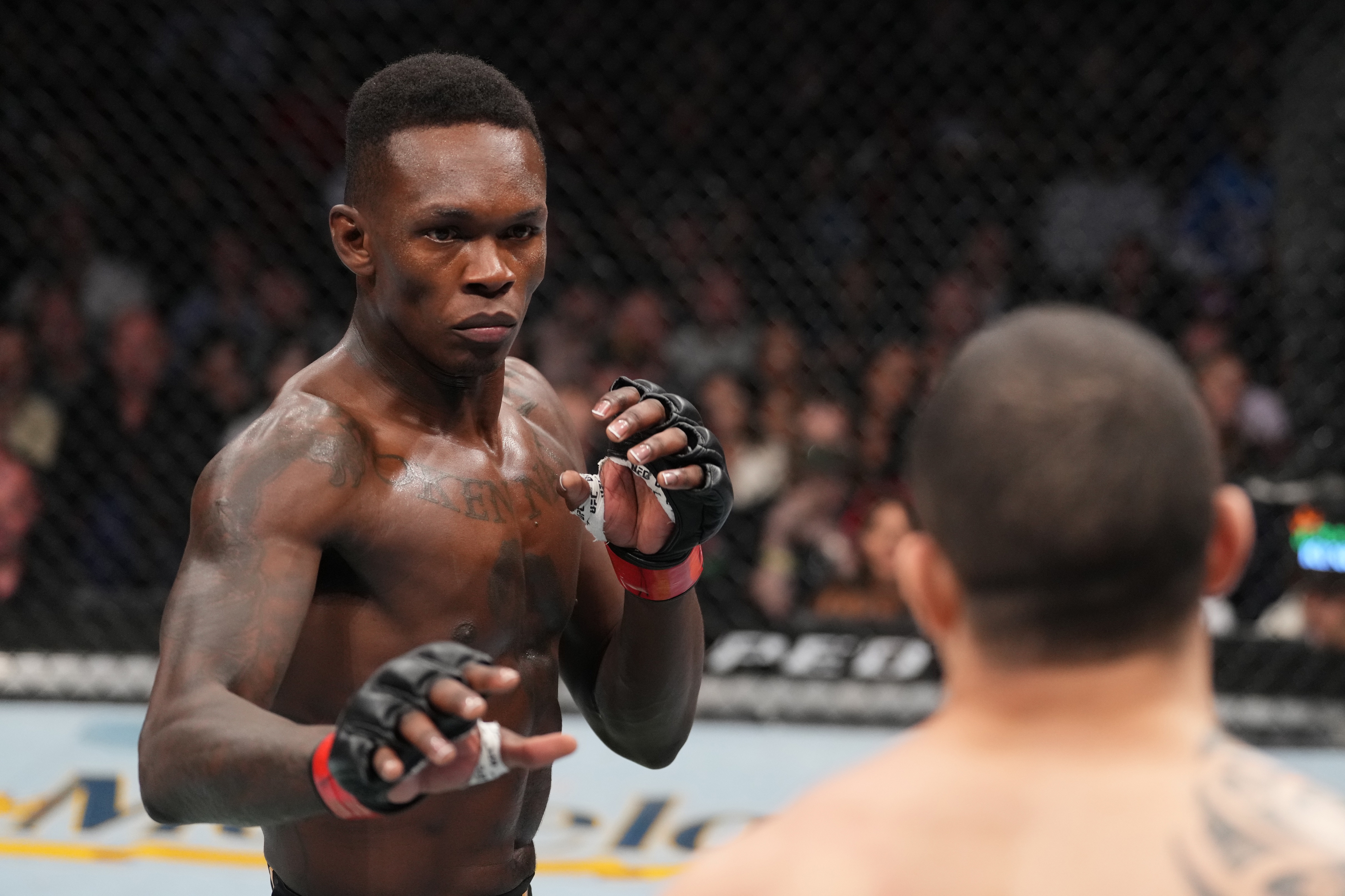 HOUSTON, TEXAS - FEBRUARY 12: (L-R) Israel Adesanya of Nigeria face \rw in their UFC middleweight championship fight during the UFC 271 event at Toyota Center on February 12, 2022 in Houston, Texas. (Photo by Josh Hedges/Zuffa LLC)