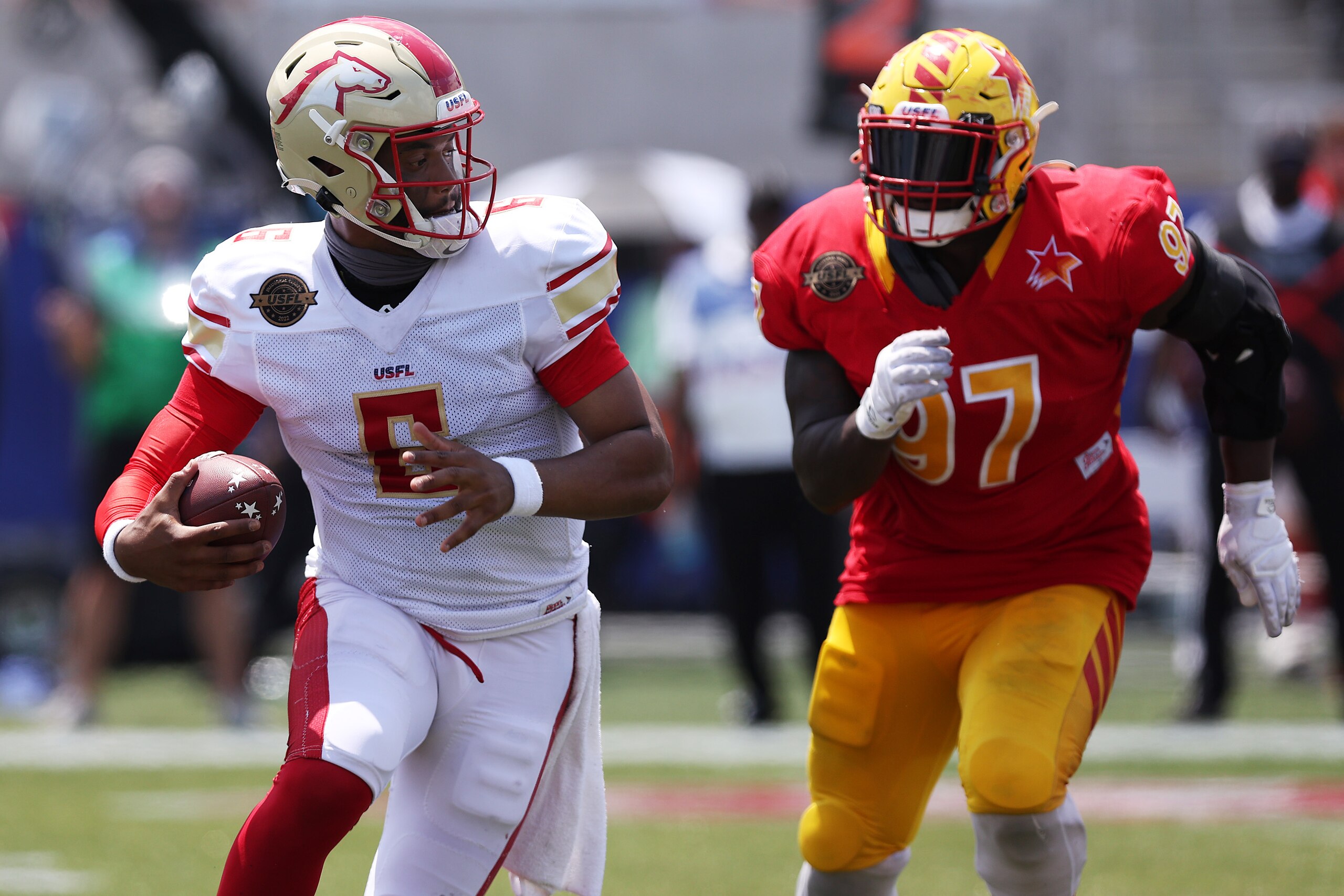 BIRMINGHAM, ALABAMA - MAY 15: J'Mar Smith #6 of Birmingham Stallions runs with the ball as Chris Nelson #97 of Philadelphia Stars runs to defend in the fourth quarter of the game at Protective Stadium on May 15, 2022 in Birmingham, Alabama. (Photo by Tom Pennington/USFL/Getty Images)