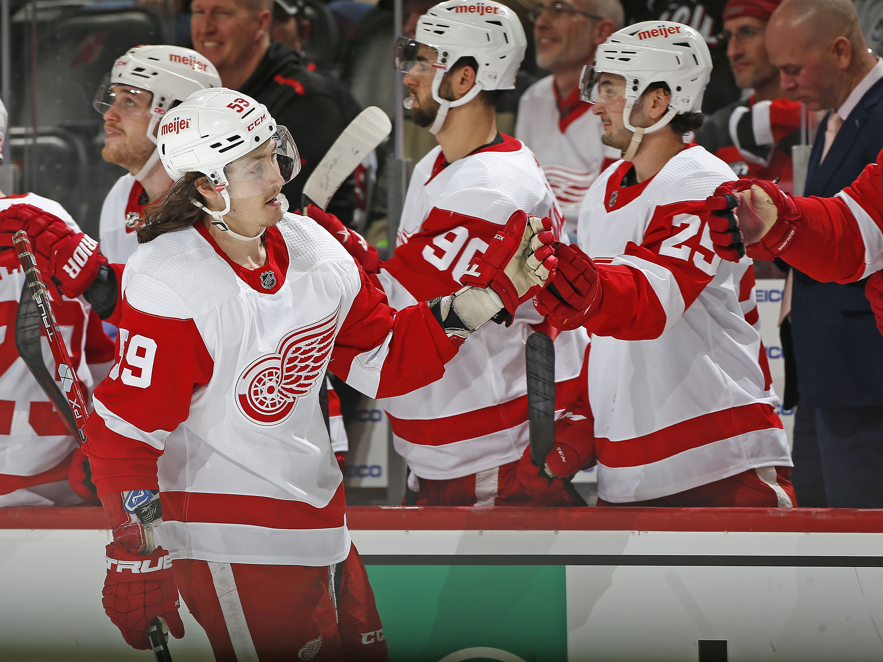 NEWARK, NJ - APRIL 24: Tyler Bertuzzi #59 of the Detroit Red Wings is congratulated as he returns to the bench after scoring an empty net goal during the third period against the New Jersey Devils at the Prudential Center on April 24, 2022 in Newark, New Jersey. The Red Wings defeated the Devils 3-0. (Photo by Christopher Pasatieri/NHLI via Getty Images)