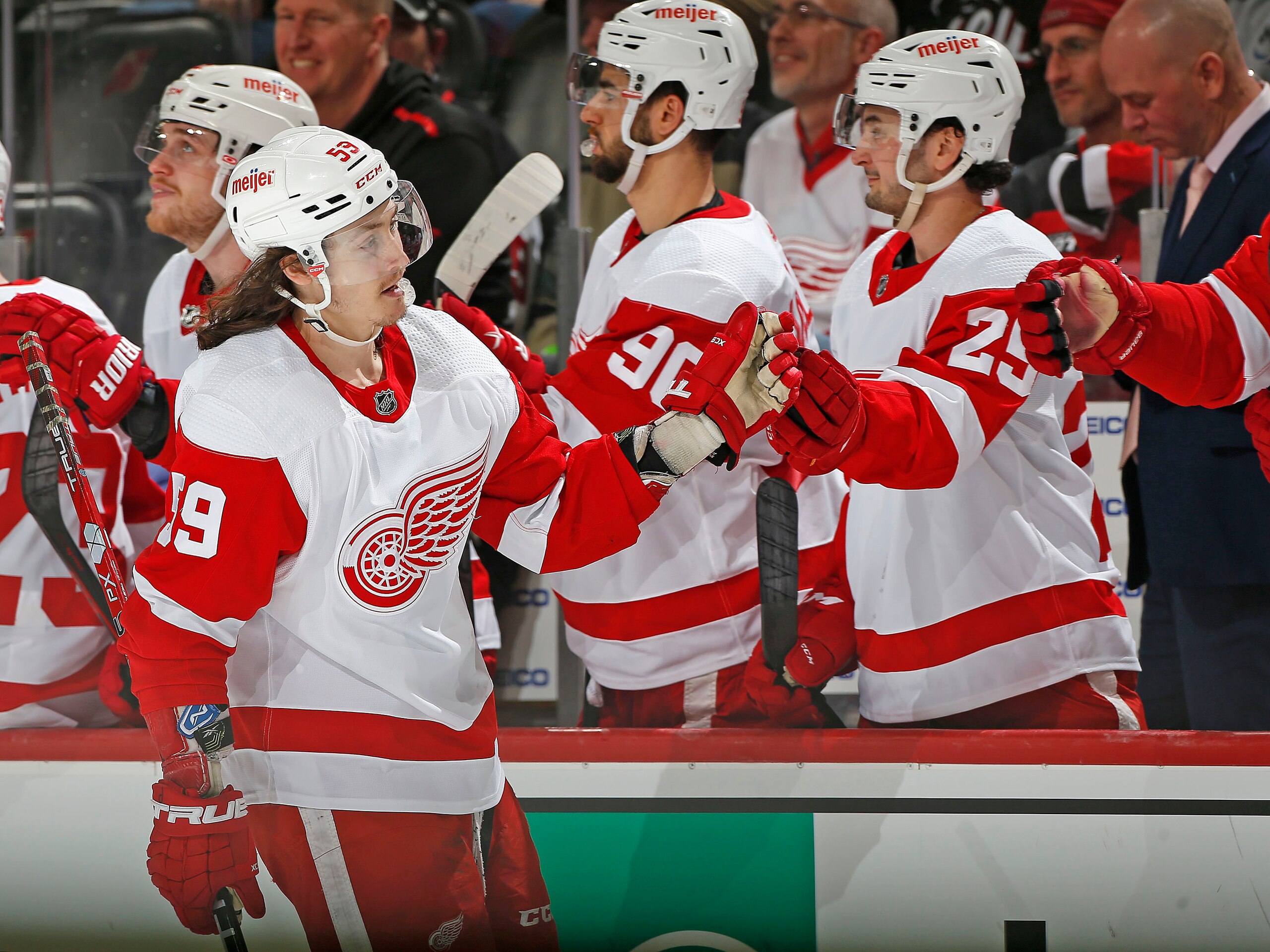 NEWARK, NJ - APRIL 24: Tyler Bertuzzi #59 of the Detroit Red Wings is congratulated as he returns to the bench after scoring an empty net goal during the third period against the New Jersey Devils at the Prudential Center on April 24, 2022 in Newark, New Jersey. The Red Wings defeated the Devils 3-0. (Photo by Christopher Pasatieri/NHLI via Getty Images)