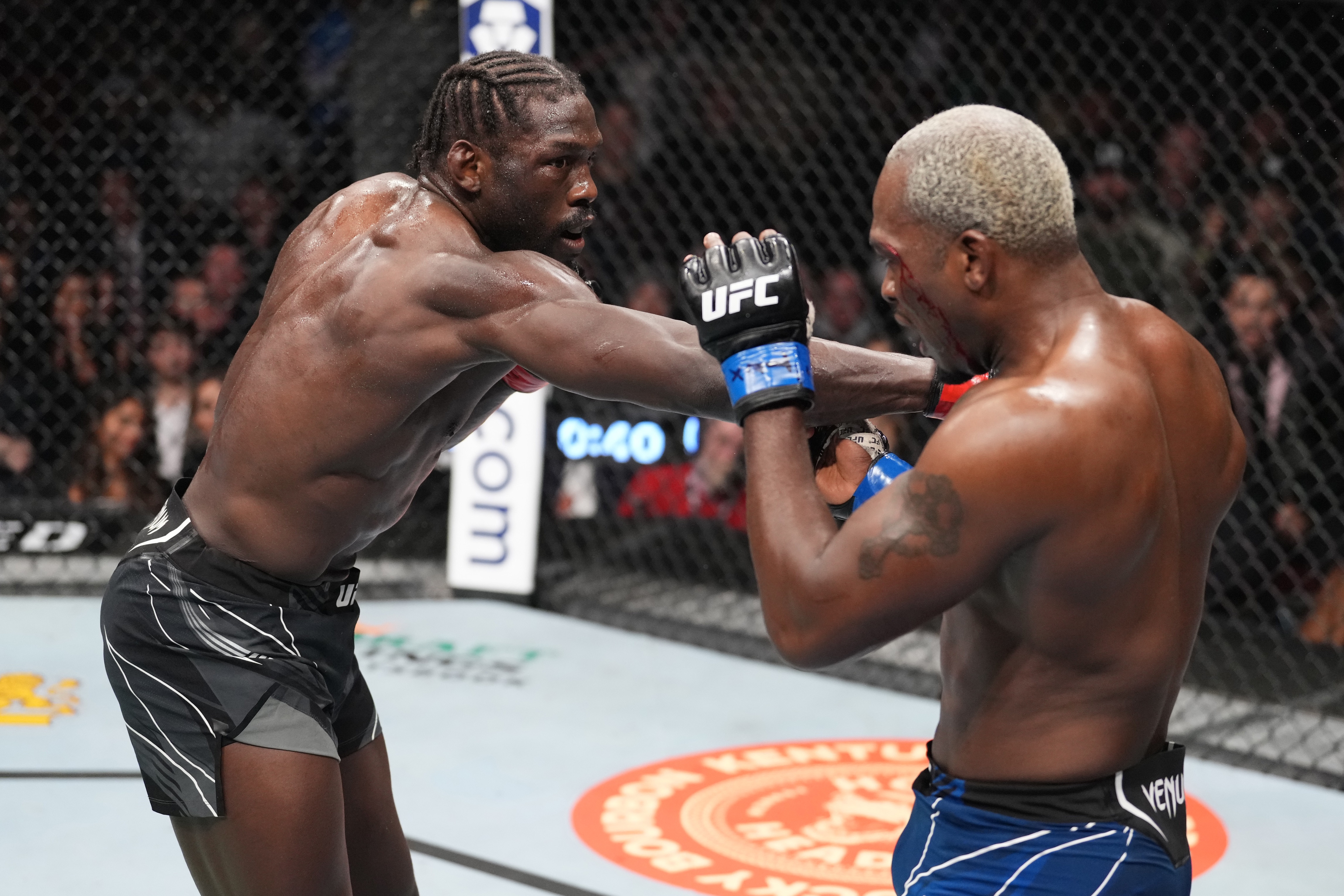 HOUSTON, TEXAS - FEBRUARY 12: (L-R) Jared Cannonier punches Derek Brunson in their middleweight fight during the UFC 271 event at Toyota Center on February 12, 2022 in Houston, Texas. (Photo by Josh Hedges/Zuffa LLC)