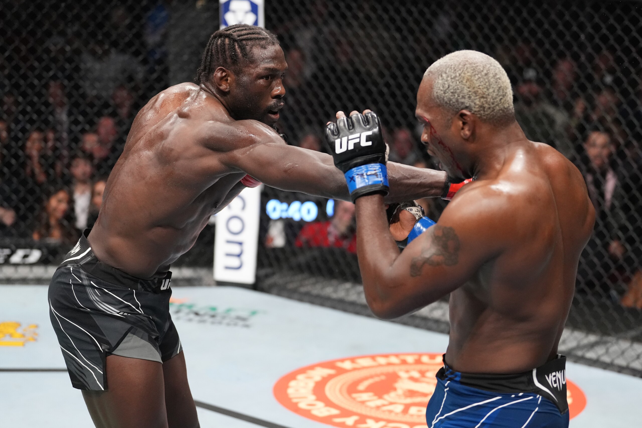 HOUSTON, TEXAS - FEBRUARY 12: (L-R) Jared Cannonier punches Derek Brunson in their middleweight fight during the UFC 271 event at Toyota Center on February 12, 2022 in Houston, Texas. (Photo by Josh Hedges/Zuffa LLC)