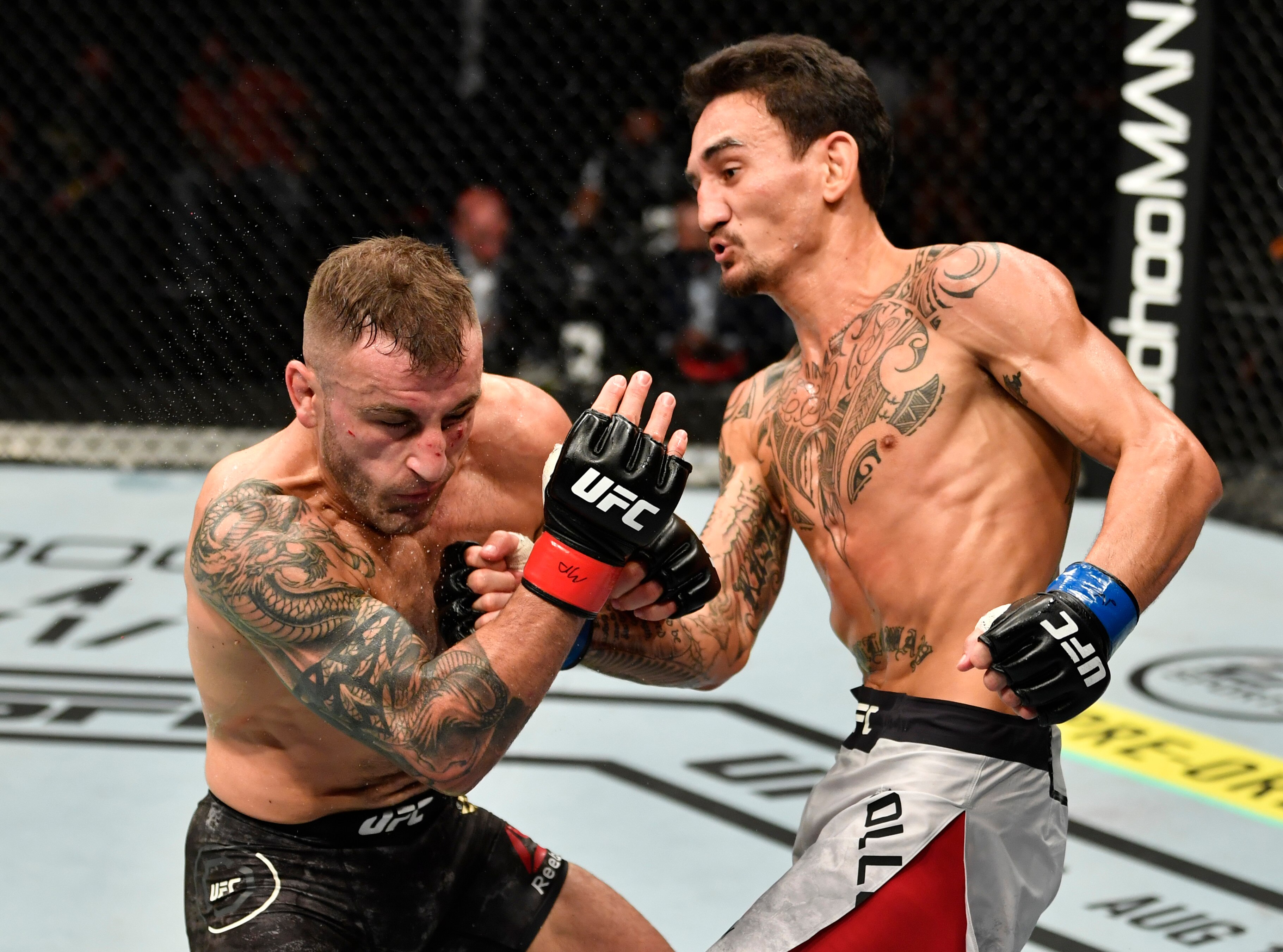 ABU DHABI, UNITED ARAB EMIRATES - JULY 12: (R-L) Max Holloway punches Alexander Volkanovski of Australia in their UFC featherweight championship fight during the UFC 251 event at Flash Forum on UFC Fight Island on July 12, 2020 on Yas Island, Abu Dhabi, United Arab Emirates. (Photo by Jeff Bottari/Zuffa LLC)