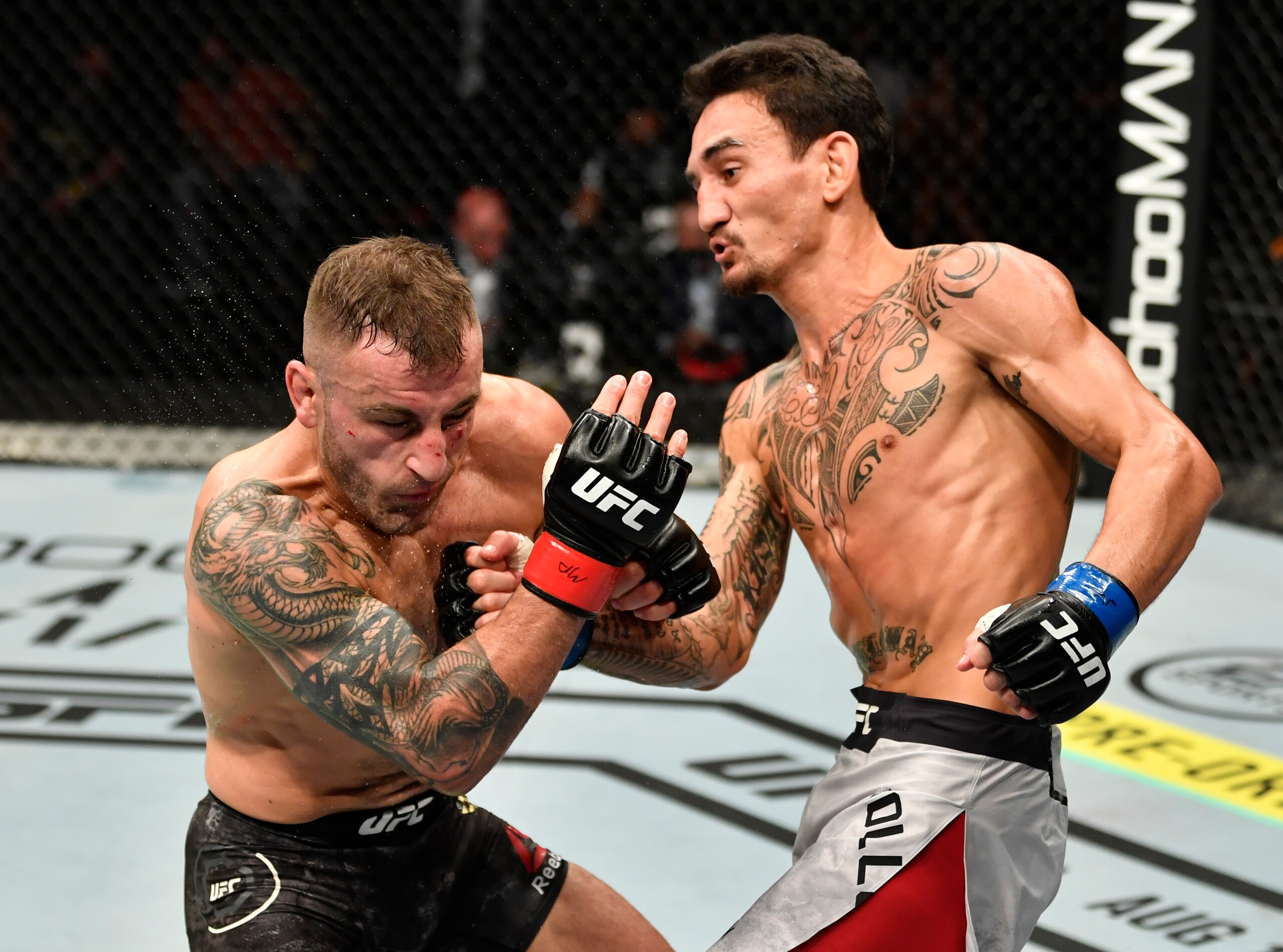 ABU DHABI, UNITED ARAB EMIRATES - JULY 12: (R-L) Max Holloway punches Alexander Volkanovski of Australia in their UFC featherweight championship fight during the UFC 251 event at Flash Forum on UFC Fight Island on July 12, 2020 on Yas Island, Abu Dhabi, United Arab Emirates. (Photo by Jeff Bottari/Zuffa LLC)