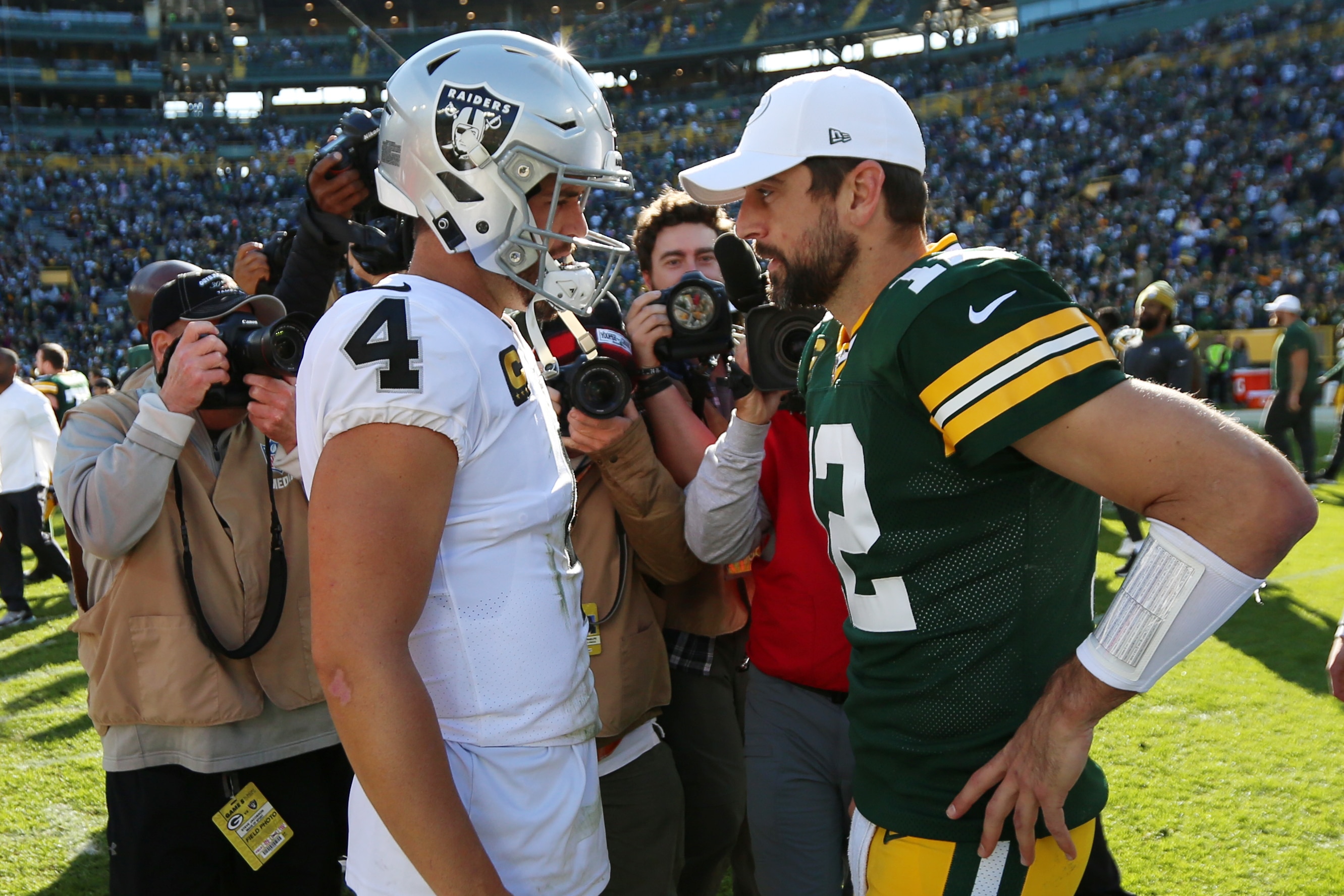 GREEN BAY, WI - OCTOBER 20: Green Bay Packers quarterback Aaron Rodgers (12) and Oakland Raiders quarterback Derek Carr (4) talk during a game between the Green Bay Packers and the Oakland Raiders at Lambeau Field on October 20, 2019 in Green Bay, WI. (Photo by Larry Radloff/Icon Sportswire via Getty Images)