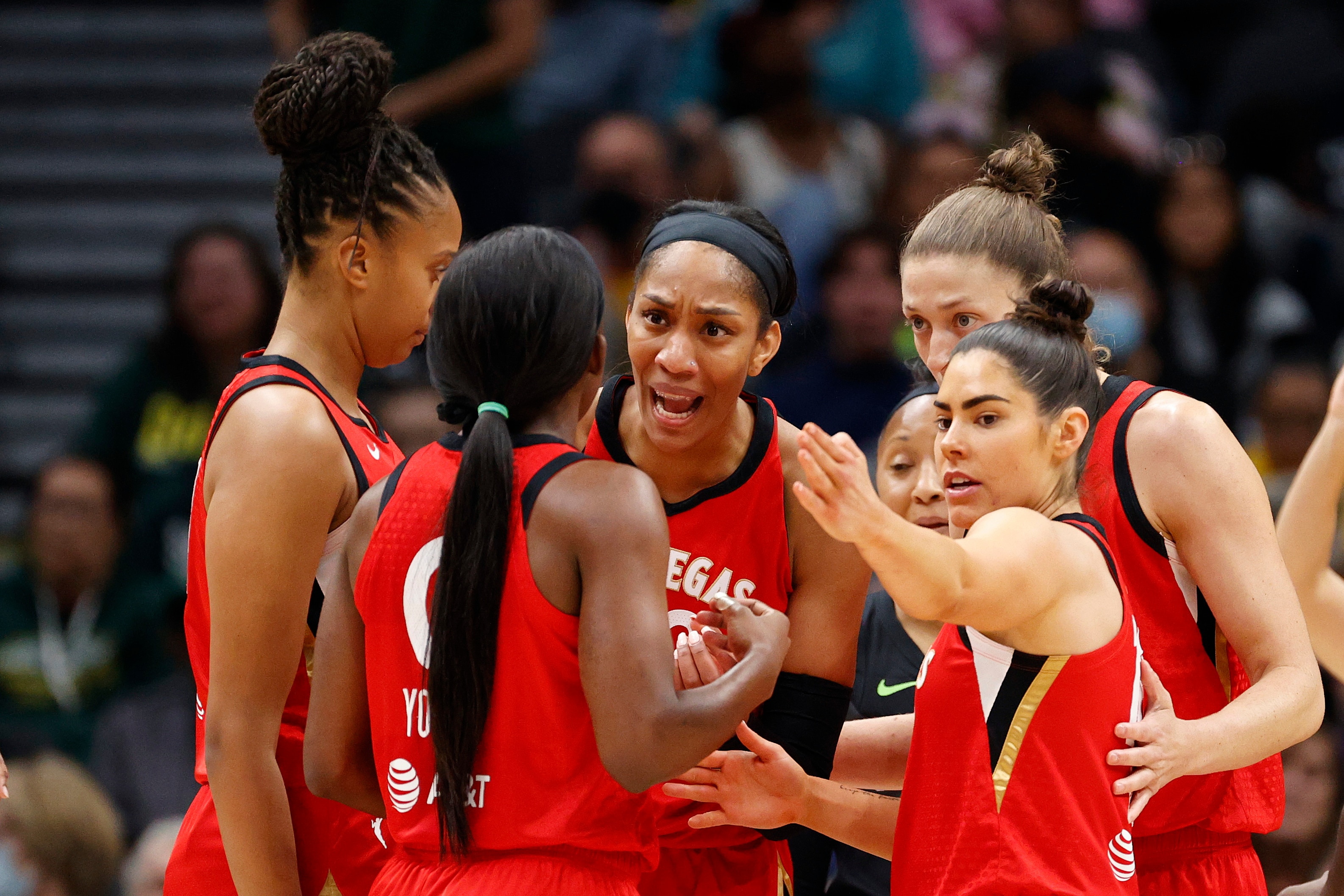 SEATTLE, WASHINGTON - JUNE 29: A'ja Wilson #22 and Kelsey Plum #10 of the Las Vegas Aces gather with teammates during the first quarter against the Seattle Storm at Climate Pledge Arena on June 29, 2022 in Seattle, Washington. (Photo by Steph Chambers/Getty Images)