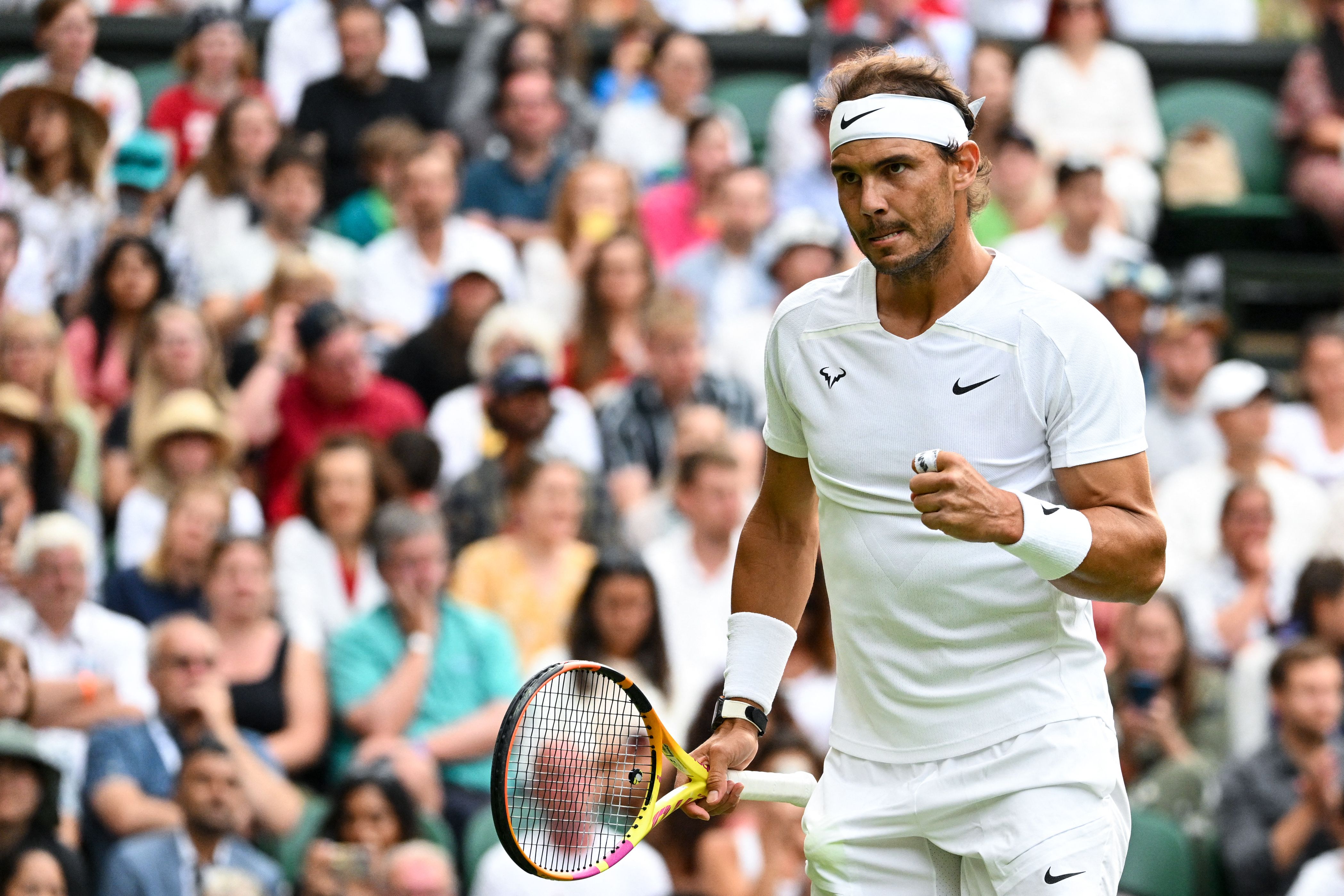 Spain's Rafael Nadal celebrates winning a point against Italy's Lorenzo Sonego during their men's singles tennis match on the sixth day of the 2022 Wimbledon Championships at The All England Tennis Club in Wimbledon, southwest London, on July 2, 2022. - RESTRICTED TO EDITORIAL USE (Photo by SEBASTIEN BOZON / AFP) / RESTRICTED TO EDITORIAL USE (Photo by SEBASTIEN BOZON/AFP via Getty Images)