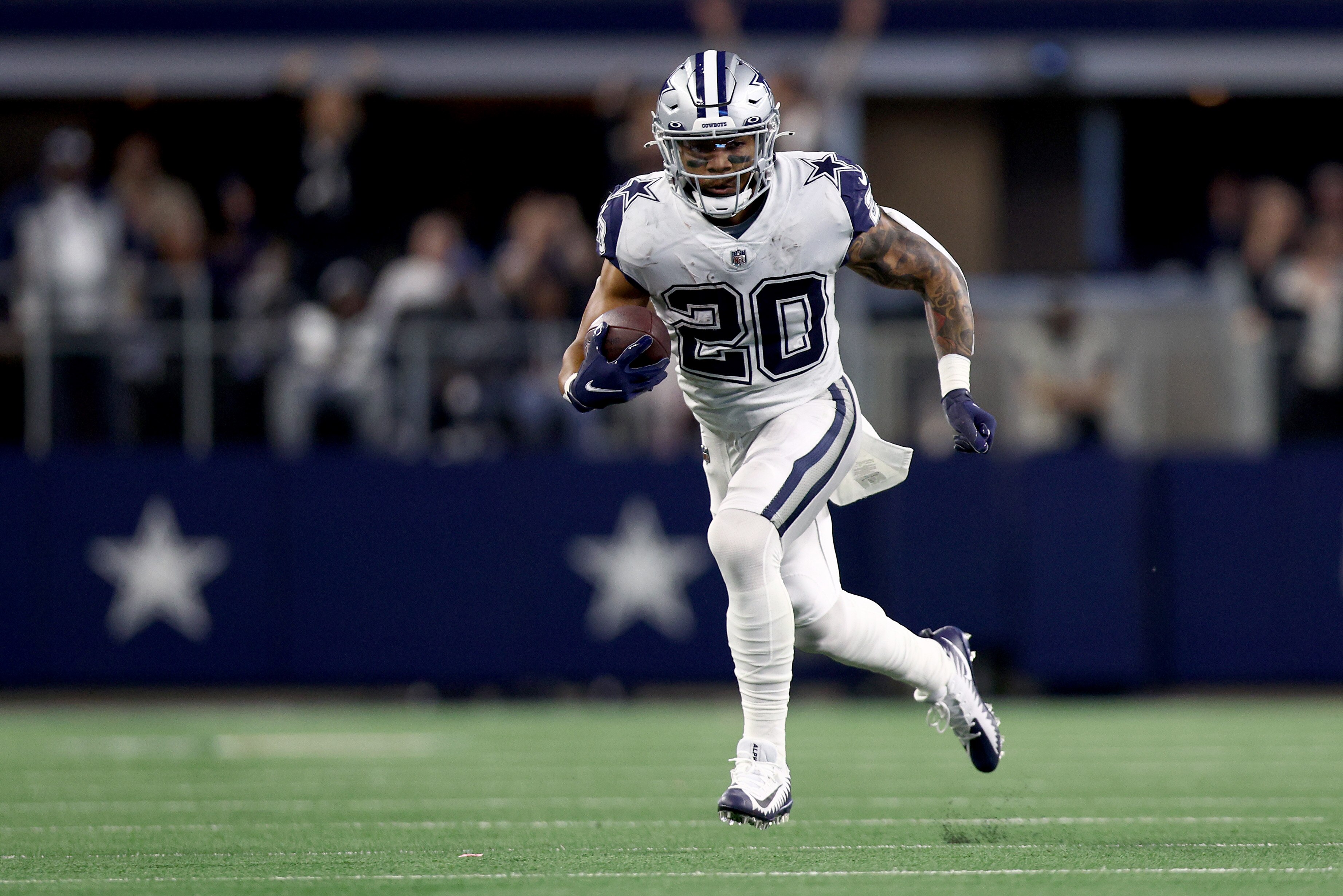ARLINGTON, TEXAS - JANUARY 02: Tony Pollard #20 of the Dallas Cowboys carries the ball against Dennis Gardeck #45 of the Arizona Cardinals in the second half at AT&T Stadium on January 02, 2022 in Arlington, Texas. (Photo by Tom Pennington/Getty Images)