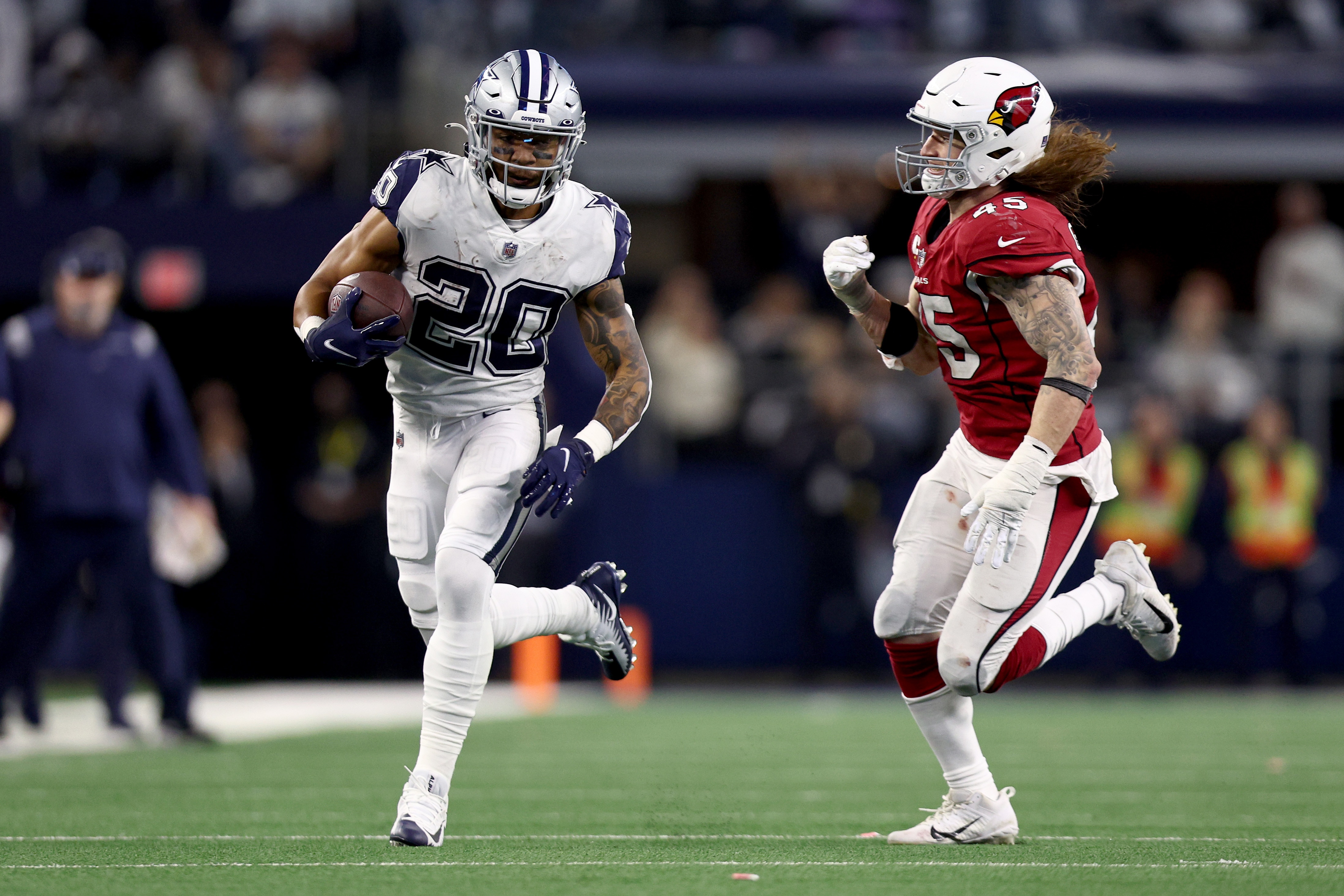 ARLINGTON, TEXAS - JANUARY 02: Tony Pollard #20 of the Dallas Cowboys carries the ball against Dennis Gardeck #45 of the Arizona Cardinals in the second half at AT&T Stadium on January 02, 2022 in Arlington, Texas. (Photo by Tom Pennington/Getty Images)