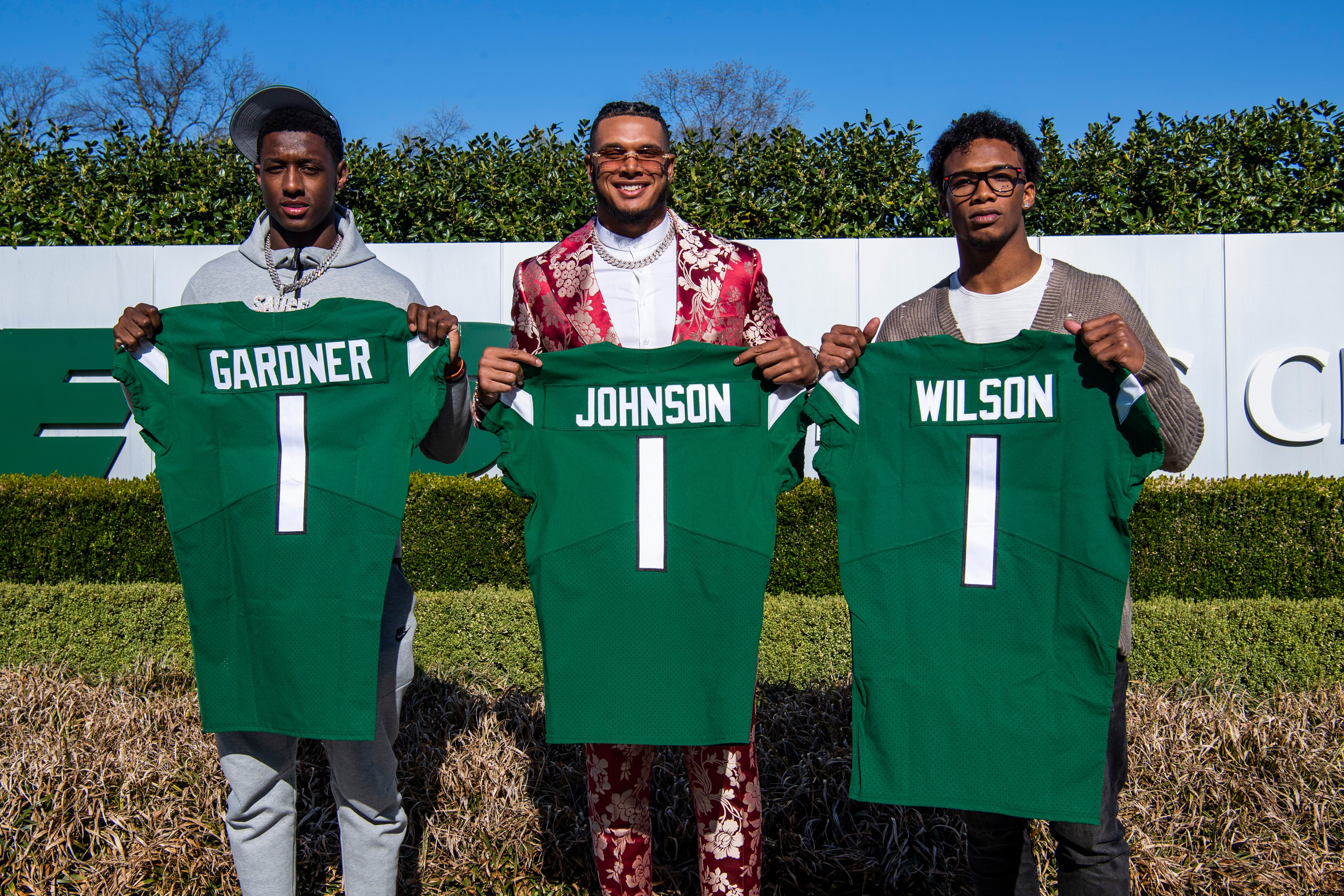 From left to right, Ahmad Gardner, Jermaine Johnson and Garrett Wilson pose for a portrait while holding New York Jets jerseys Friday, April 29, 2022, in Florham Park, N.J. (AP Photo/Brittainy Newman)