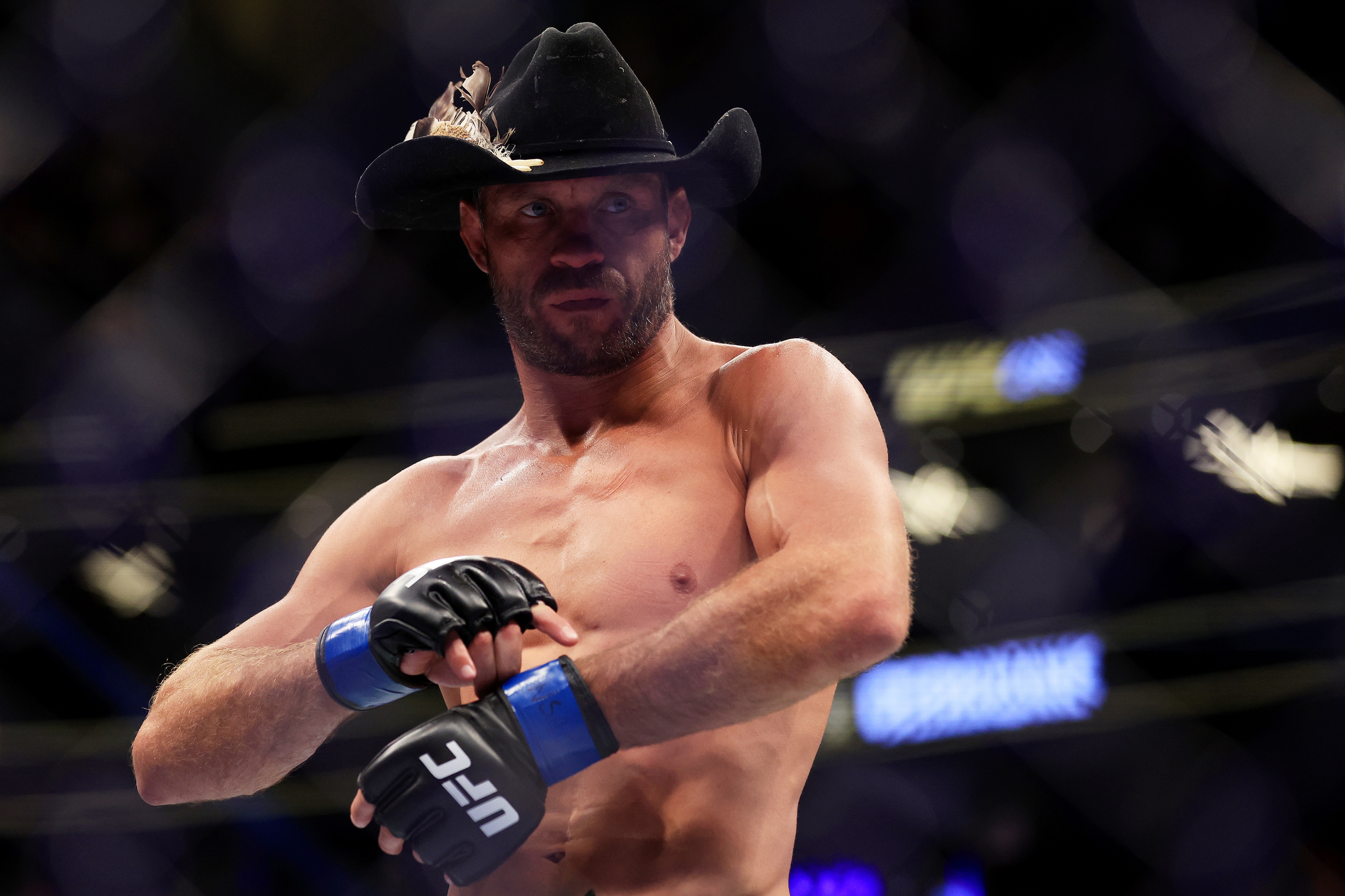 LAS VEGAS, NEVADA - JULY 02: Donald Cerrone takes off his gloves as he announces his retirement after his welterweight bout against Jim Miller during UFC 276 at T-Mobile Arena on July 02, 2022 in Las Vegas, Nevada. Jim Miller won via a second round submission. (Photo by Carmen Mandato/Getty Images)