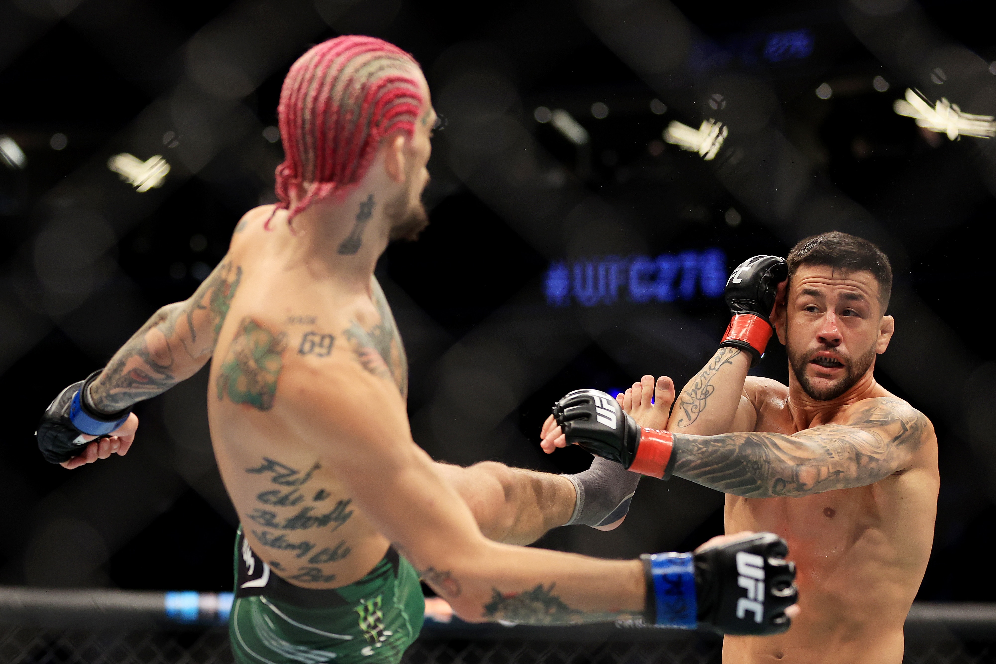 LAS VEGAS, NEVADA - JULY 02: Sean O'Malley (L) kicks Pedro Munhoz of Brazil in their bantamweight bout during UFC 276 at T-Mobile Arena on July 02, 2022 in Las Vegas, Nevada. (Photo by Carmen Mandato/Getty Images)