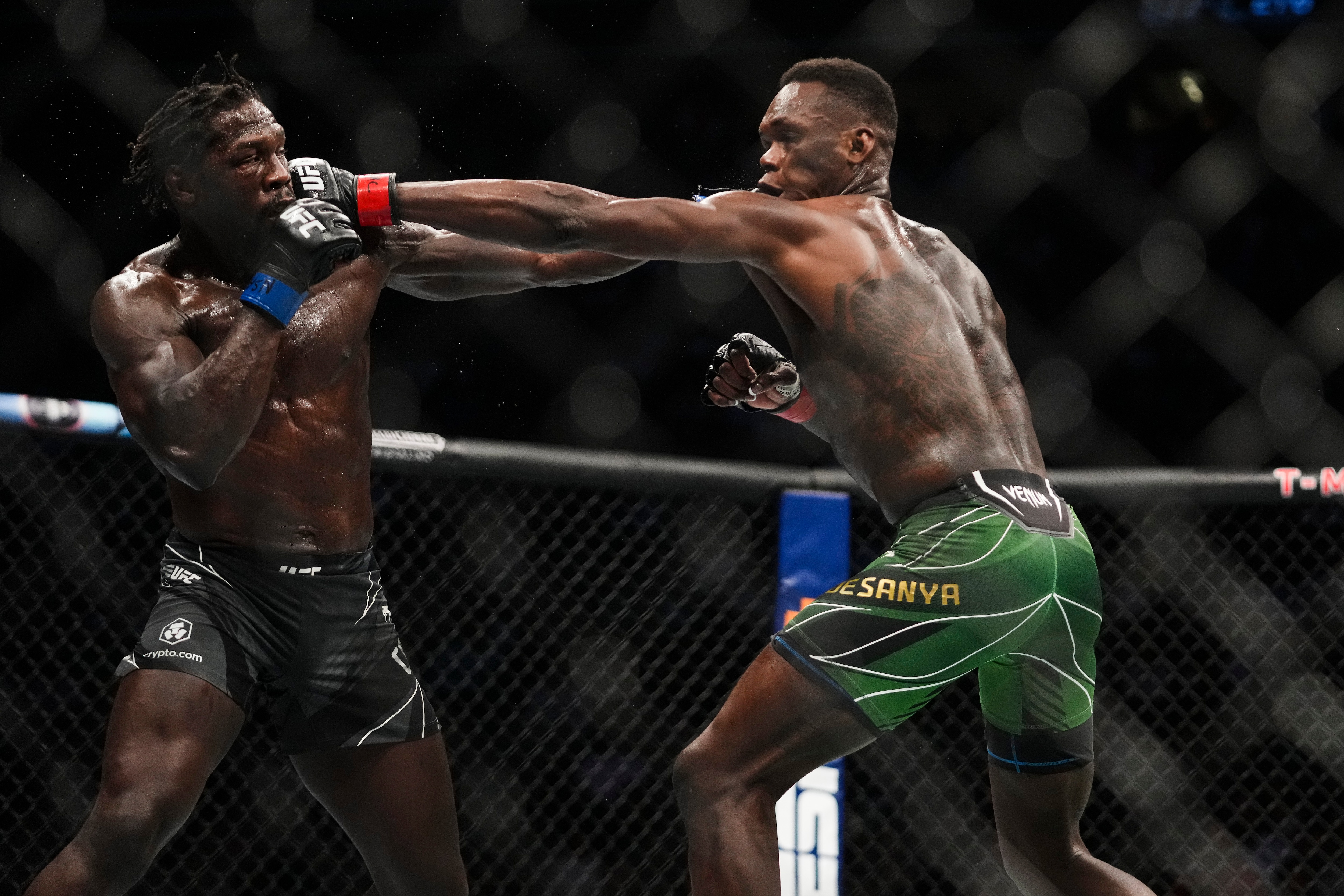 LAS VEGAS, NEVADA - JULY 02: Jared Cannonier and Israel Adesanya of Nigeria trade blows in the UFC middleweight championship fight during the UFC 276 event at T-Mobile Arena on July 02, 2022 in Las Vegas, Nevada. (Photo by Cooper Neill/Zuffa LLC)