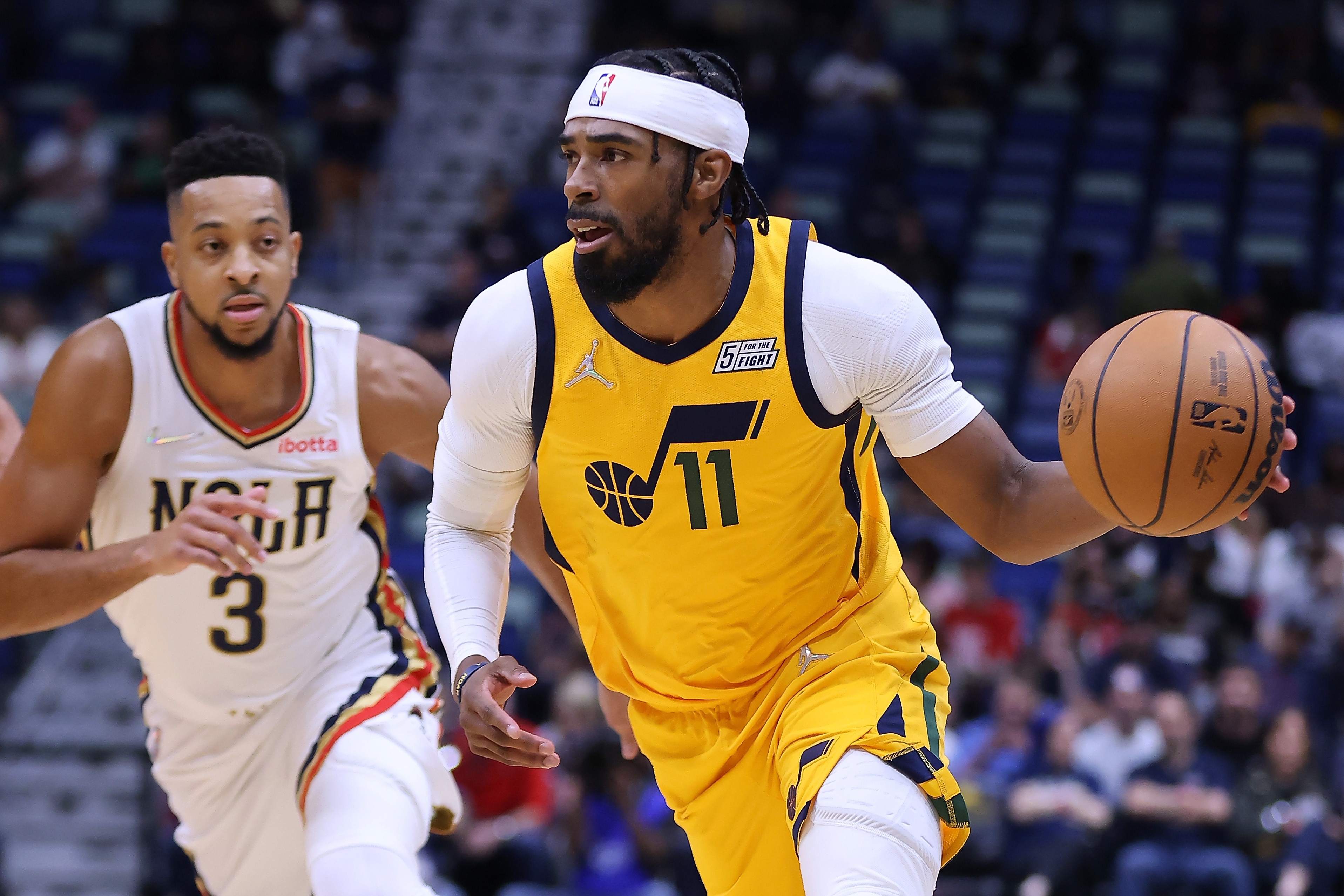 NEW ORLEANS, LOUISIANA - MARCH 04: Mike Conley #11 of the Utah Jazz drives against CJ McCollum #3 of the New Orleans Pelicans during the first half at the Smoothie King Center on March 04, 2022 in New Orleans, Louisiana. NOTE TO USER: User expressly acknowledges and agrees that, by downloading and or using this Photograph, user is consenting to the terms and conditions of the Getty Images License Agreement. (Photo by Jonathan Bachman/Getty Images)