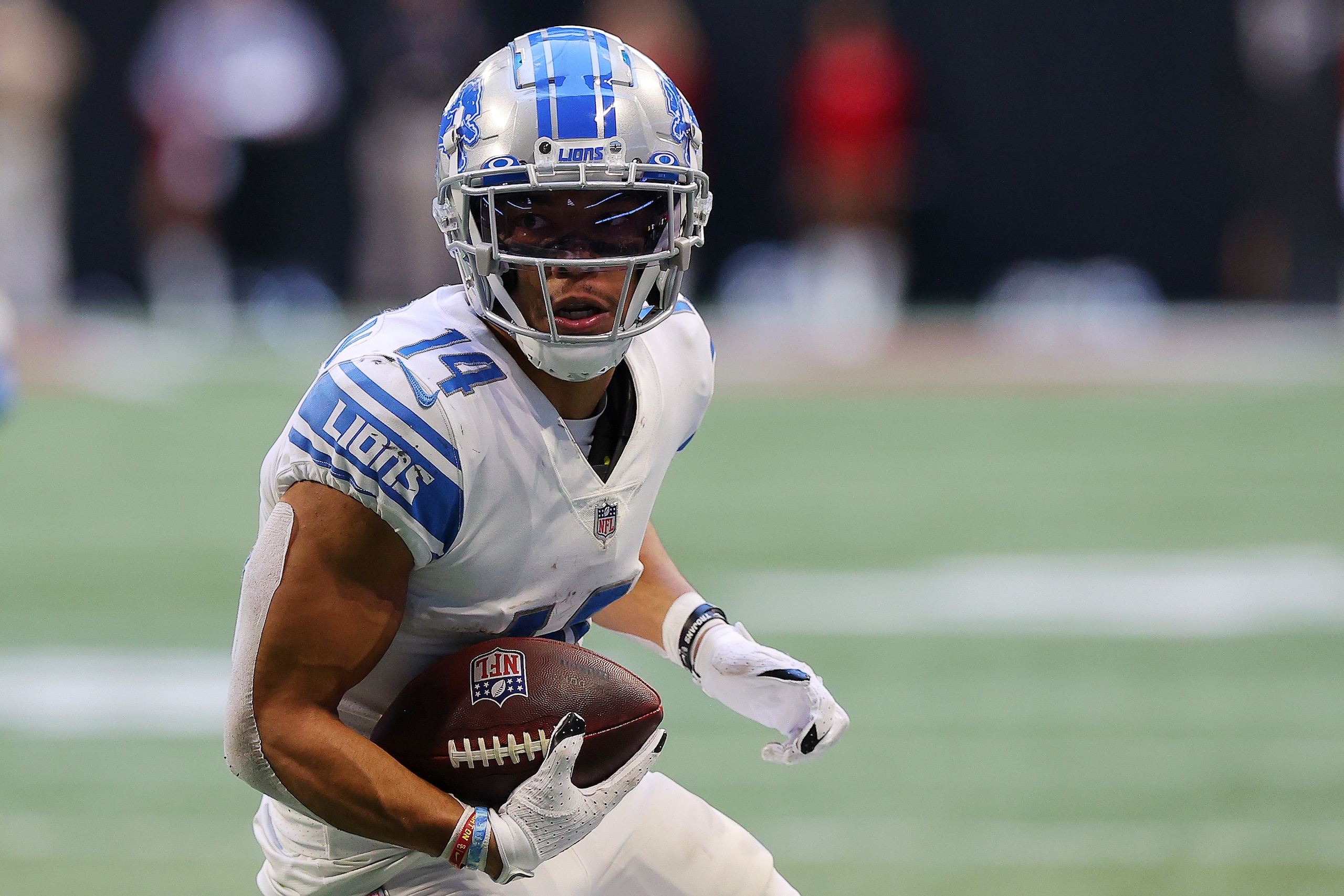ATLANTA, GEORGIA - DECEMBER 26: Amon-Ra St. Brown #14 of the Detroit Lions runs with the ball after the catch in the third quarter against the Atlanta Falcons at Mercedes-Benz Stadium on December 26, 2021 in Atlanta, Georgia. (Photo by Todd Kirkland/Getty Images)