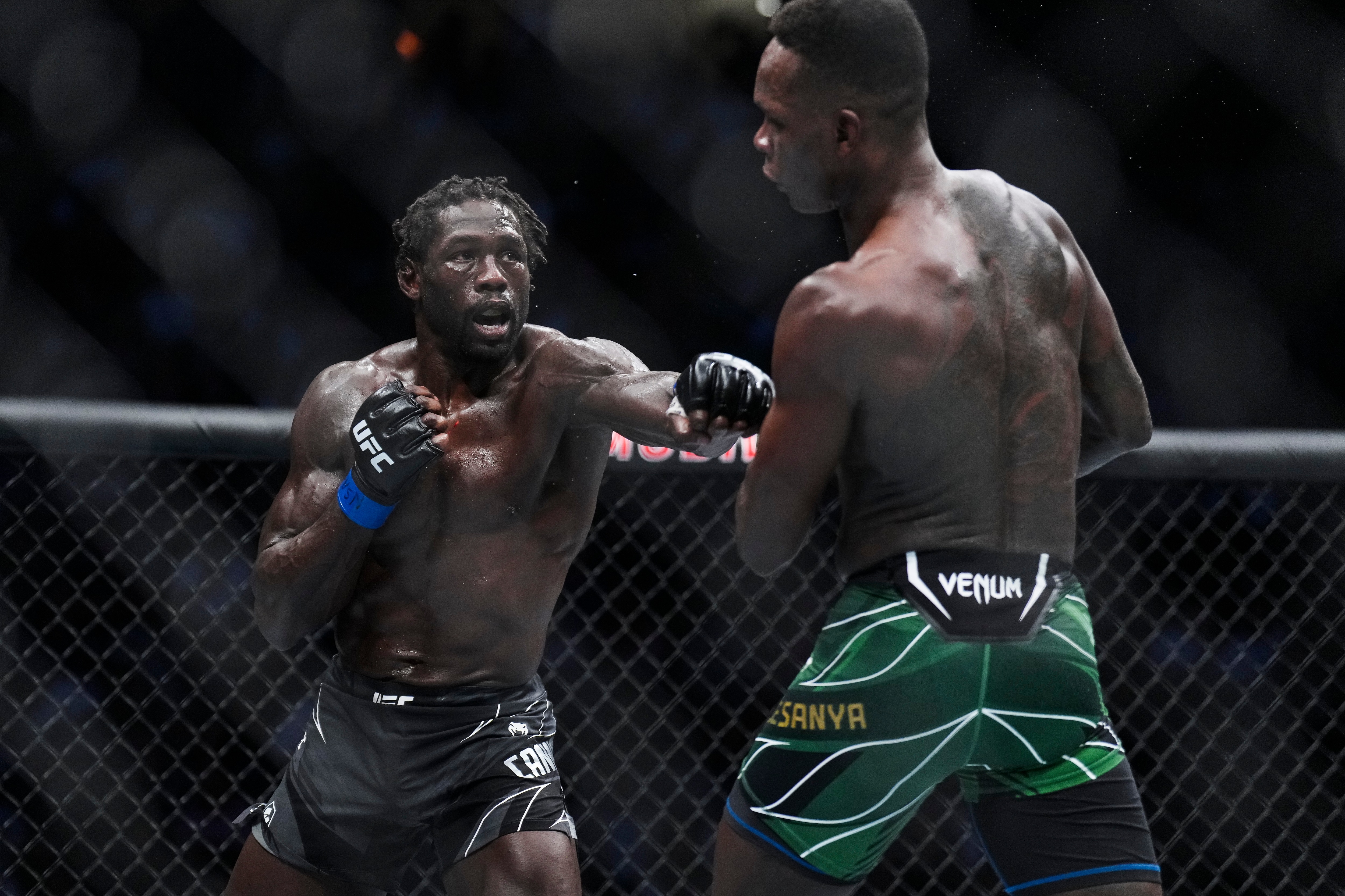 LAS VEGAS, NEVADA - JULY 02: Jared Cannonier punches Israel Adesanya of Nigeria in the UFC middleweight championship fight during the UFC 276 event at T-Mobile Arena on July 02, 2022 in Las Vegas, Nevada. (Photo by Chris Unger/Zuffa LLC)