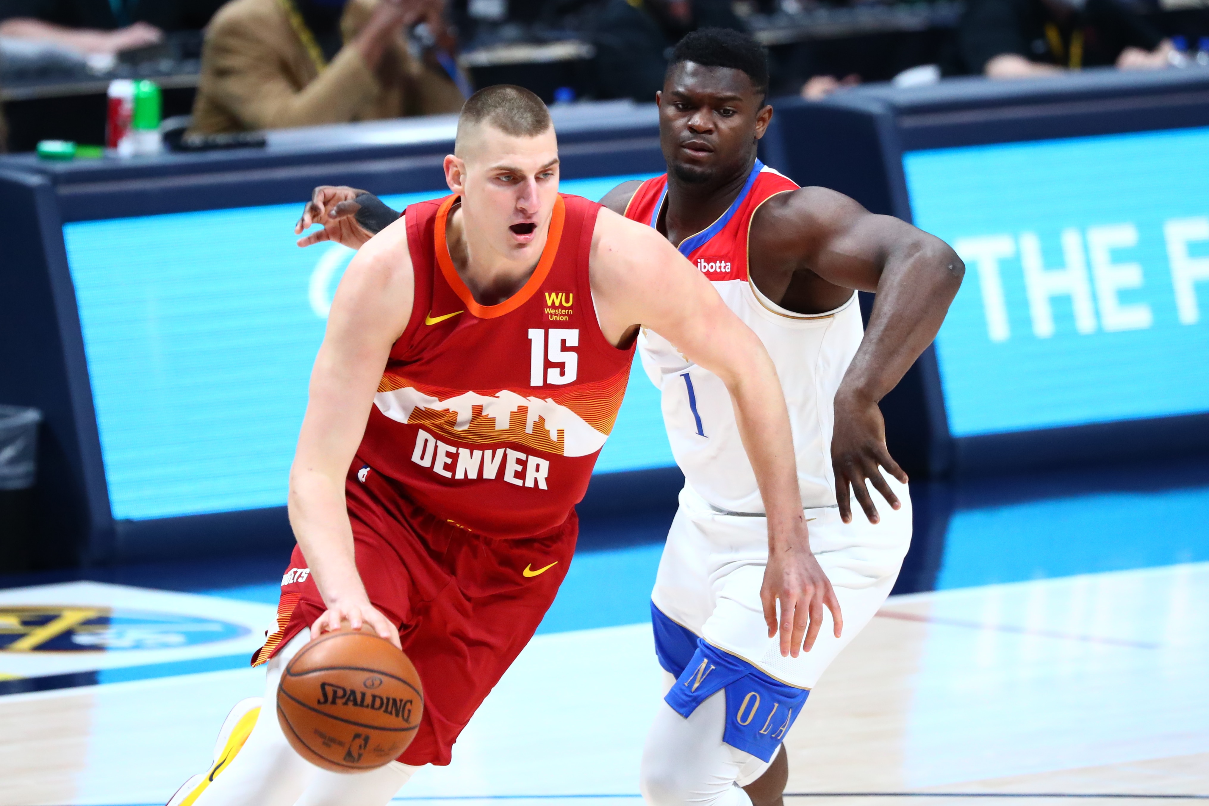 DENVER, CO - APRIL 28: Nikola Jokic #15 of the Denver Nuggets drives to the basket past Zion Williamson #1 of the New Orleans Pelicans during the first quarter at Ball Arena on April 28, 2021 in Denver, Colorado. NOTE TO USER: User expressly acknowledges and agrees that, by downloading and or using this photograph, User is consenting to the terms and conditions of the Getty Images License Agreement.  (Photo by C. Morgan Engel/Getty Images)