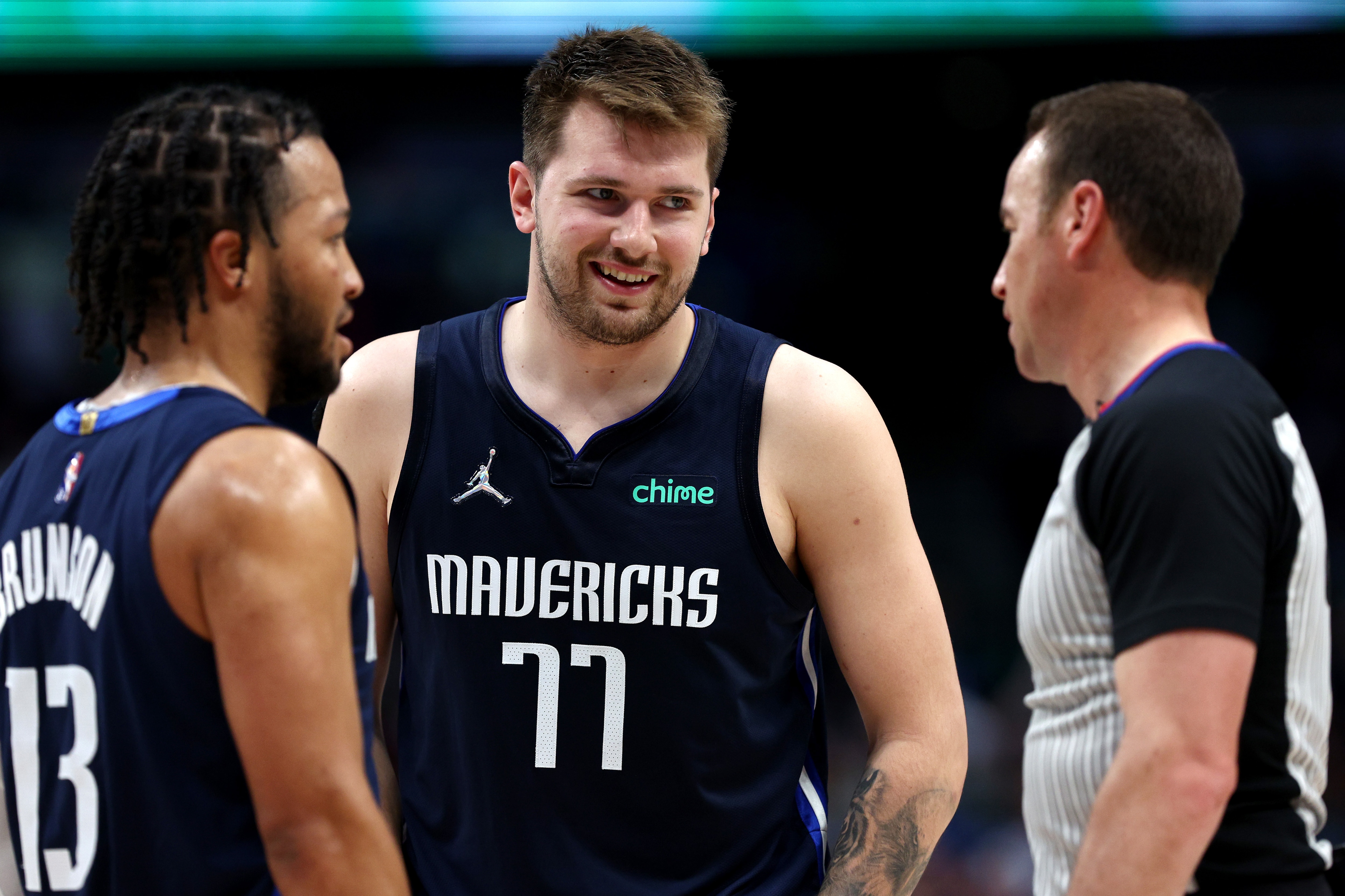 DALLAS, TEXAS - MAY 22: Luka Doncic #77 and Jalen Brunson #13 of the Dallas Mavericks argue with the referee during the second quarter against the Golden State Warriors in Game Three of the 2022 NBA Playoffs Western Conference Finals at American Airlines Center on May 22, 2022 in Dallas, Texas. NOTE TO USER: User expressly acknowledges and agrees that, by downloading and or using this photograph, User is consenting to the terms and conditions of the Getty Images License Agreement. (Photo by Tom Pennington/Getty Images)