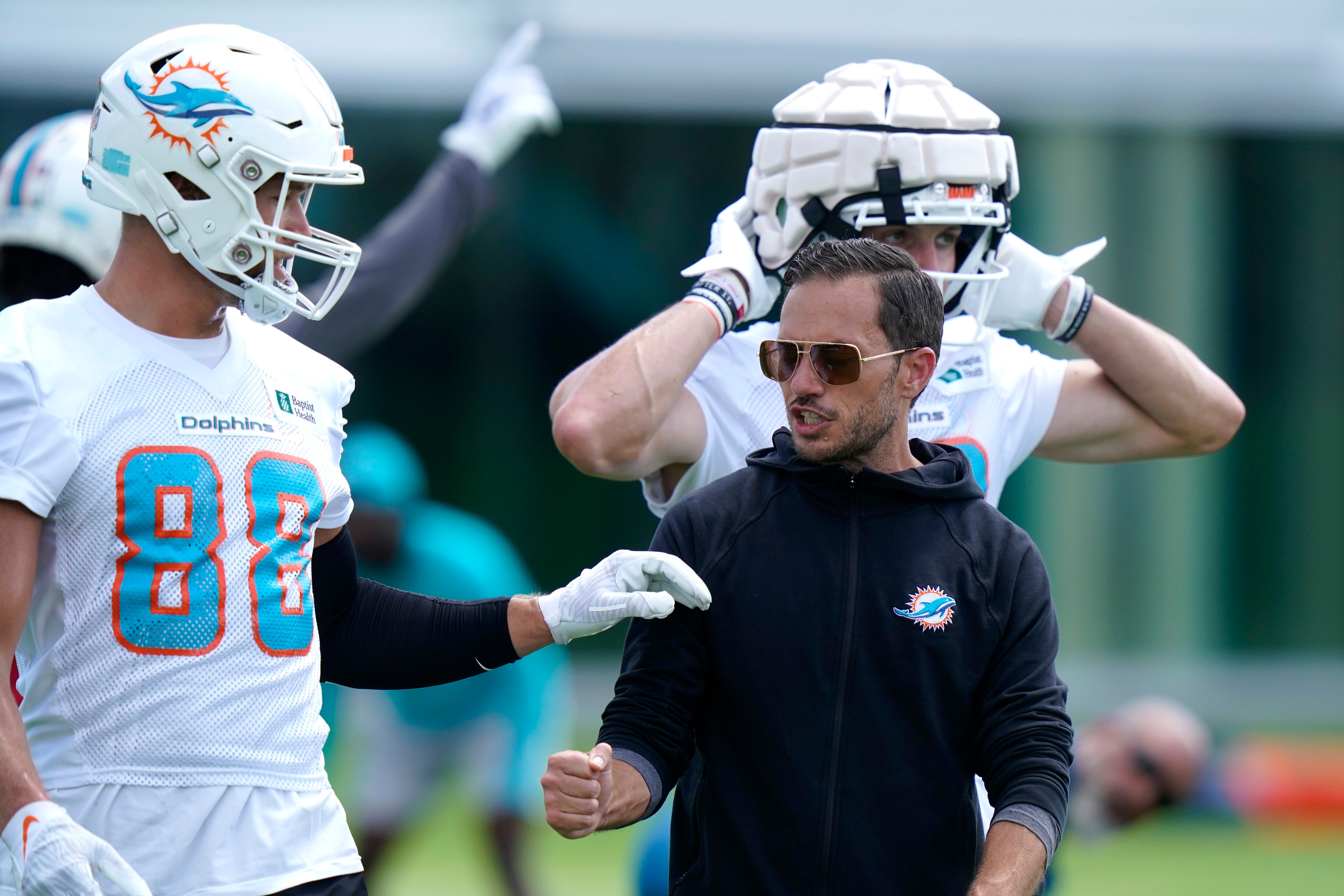 Miami Dolphins wide receiver Mike Gesicki (88) talks with head coach Mike McDaniel at the NFL football team's practice facility, Wednesday, June 1, 2022, in Miami Gardens, Fla. (AP Photo/Lynne Sladky)