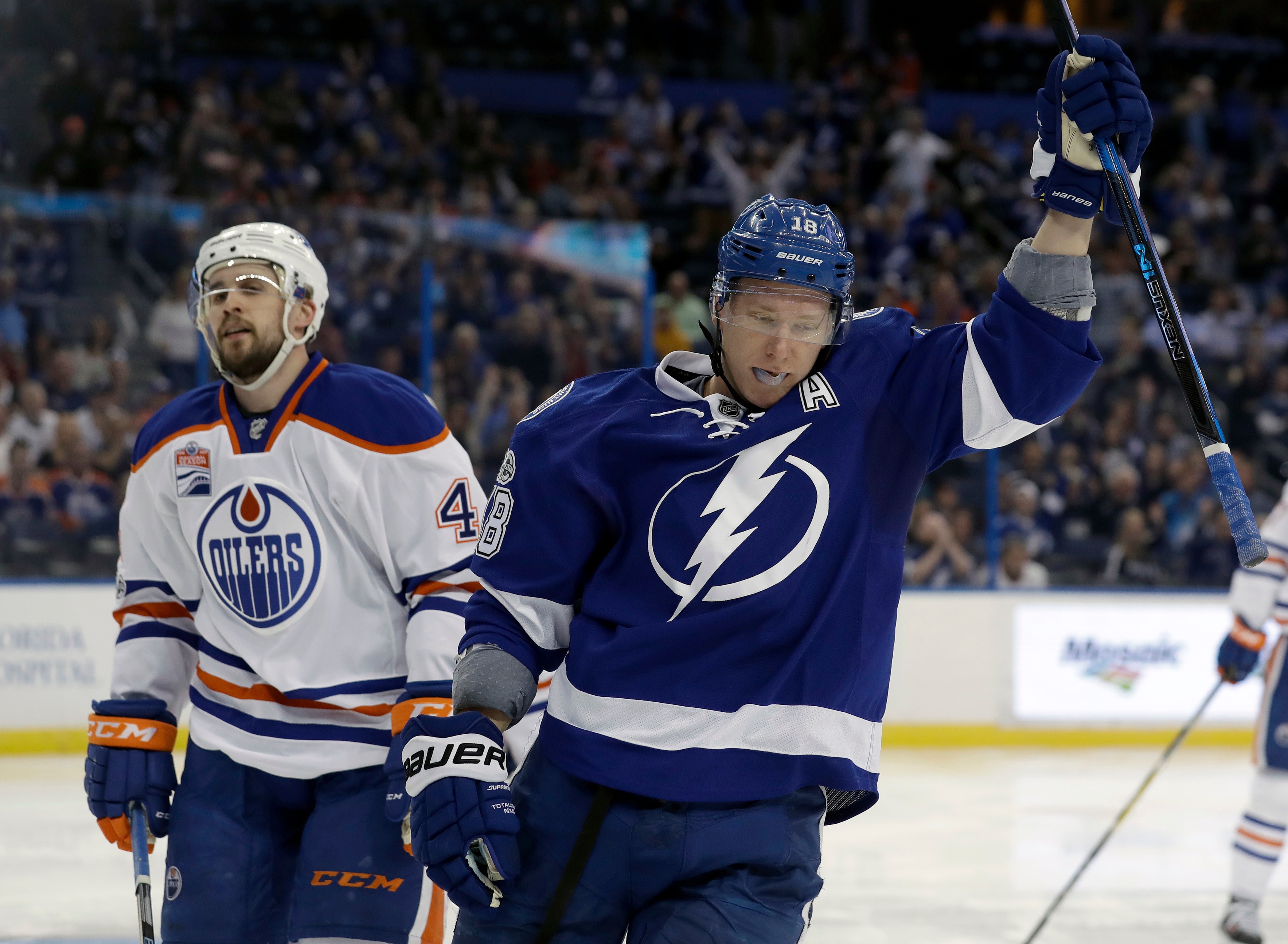 Tampa Bay Lightning left wing Ondrej Palat (18), of the Czech Republic, celebrates in front of Edmonton Oilers defenseman Kris Russell (4) after scoring during the second period of an NHL hockey game Tuesday, Feb. 21, 2017, in Tampa, Fla. (AP Photo/Chris O'Meara)