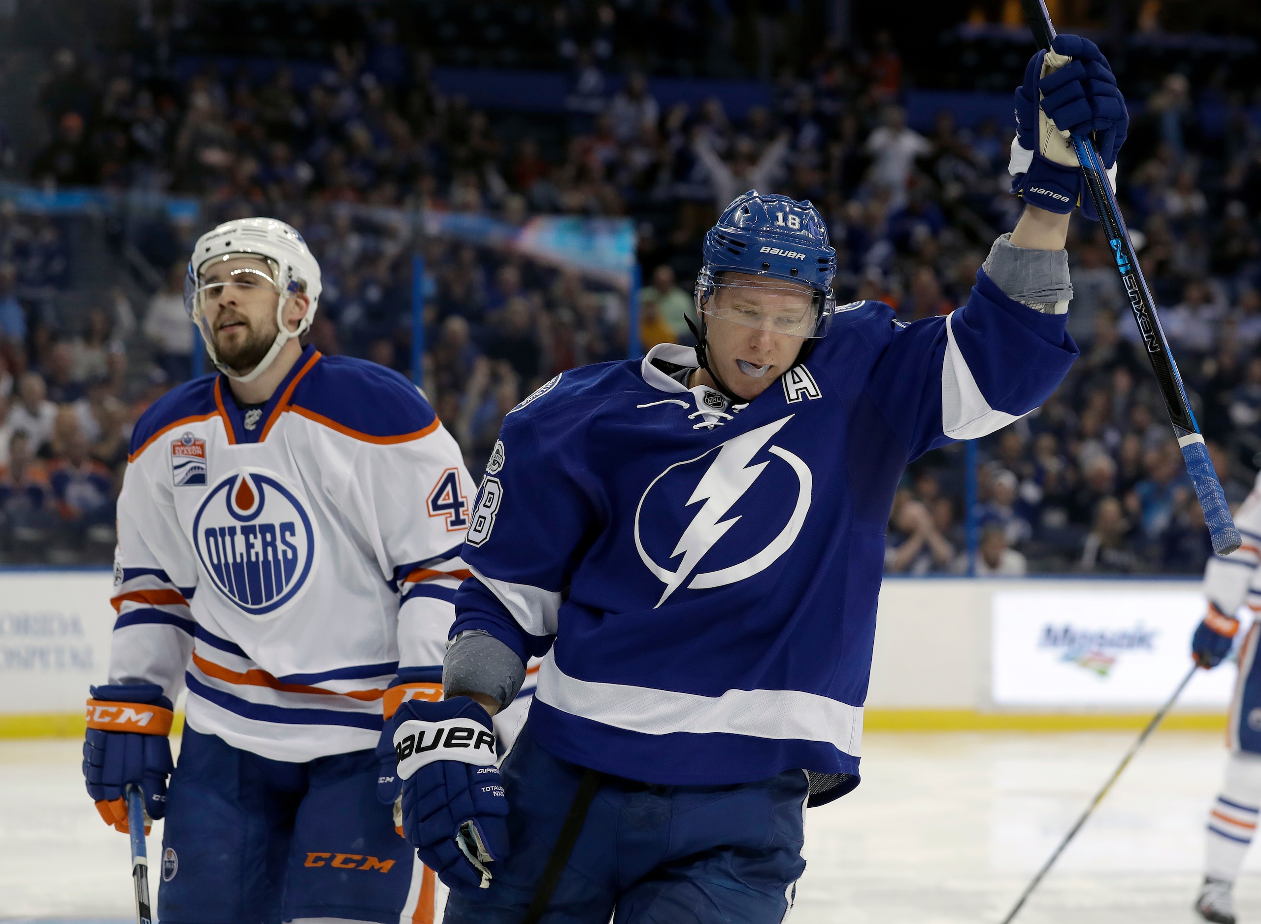 Tampa Bay Lightning left wing Ondrej Palat (18), of the Czech Republic, celebrates in front of Edmonton Oilers defenseman Kris Russell (4) after scoring during the second period of an NHL hockey game Tuesday, Feb. 21, 2017, in Tampa, Fla. (AP Photo/Chris O'Meara)