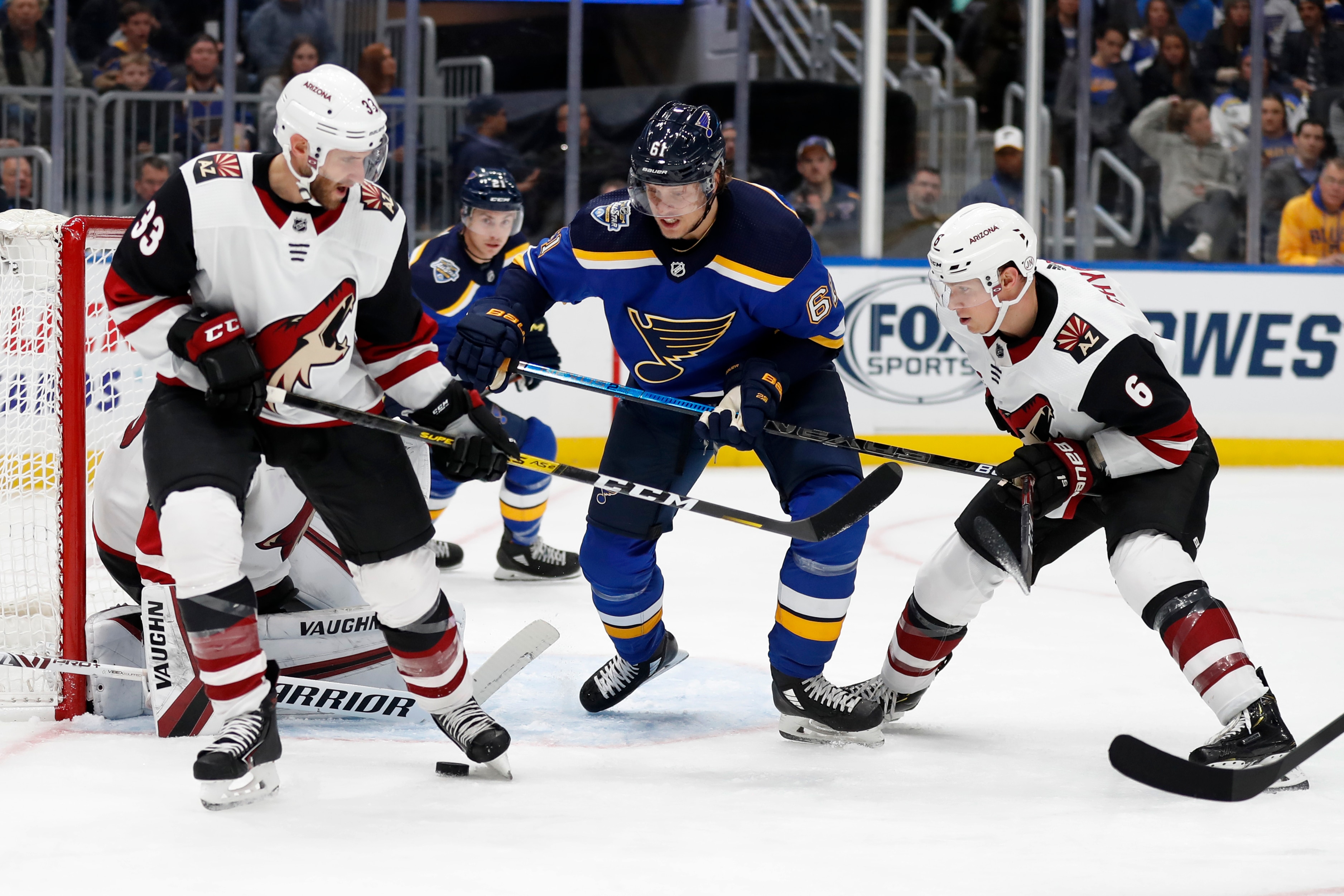 St. Louis Blues' Jacob de la Rose (61) watches the puck between Arizona Coyotes' Alex Goligoski (33) and Jakob Chychrun (6) during the second period of an NHL hockey game Tuesday, Nov. 12, 2019, in St. Louis. (AP Photo/Jeff Roberson)