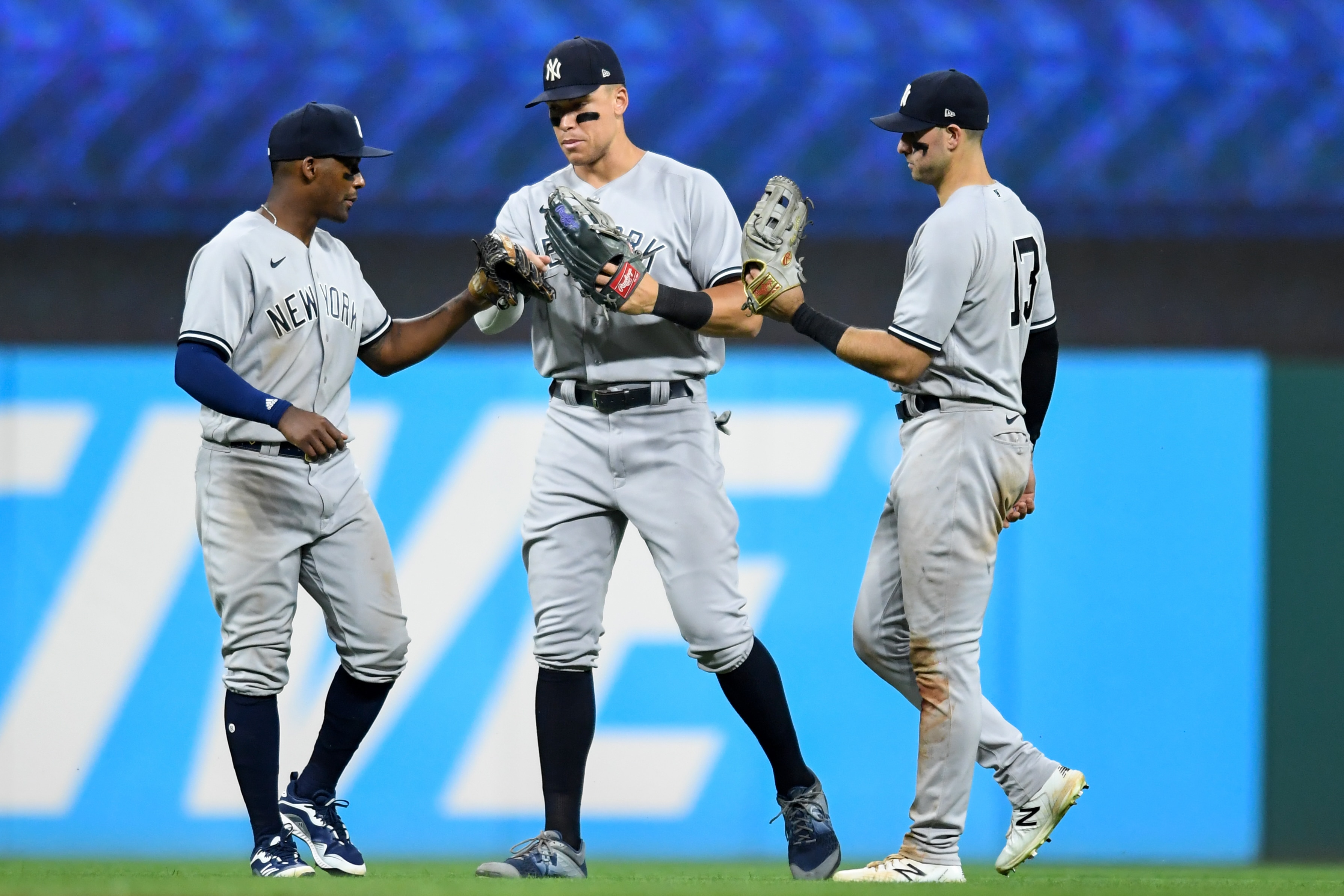 CLEVELAND, OH - JULY 02: Miguel Andújar #41, Aaron Judge #99 and Joey Gallo #13 of the New York Yankees celebrate the teams 6-1 win over the Cleveland Guardians in game two of a doubleheader at Progressive Field on July 2, 2022 in Cleveland, Ohio. (Photo by Nick Cammett/Getty Images)