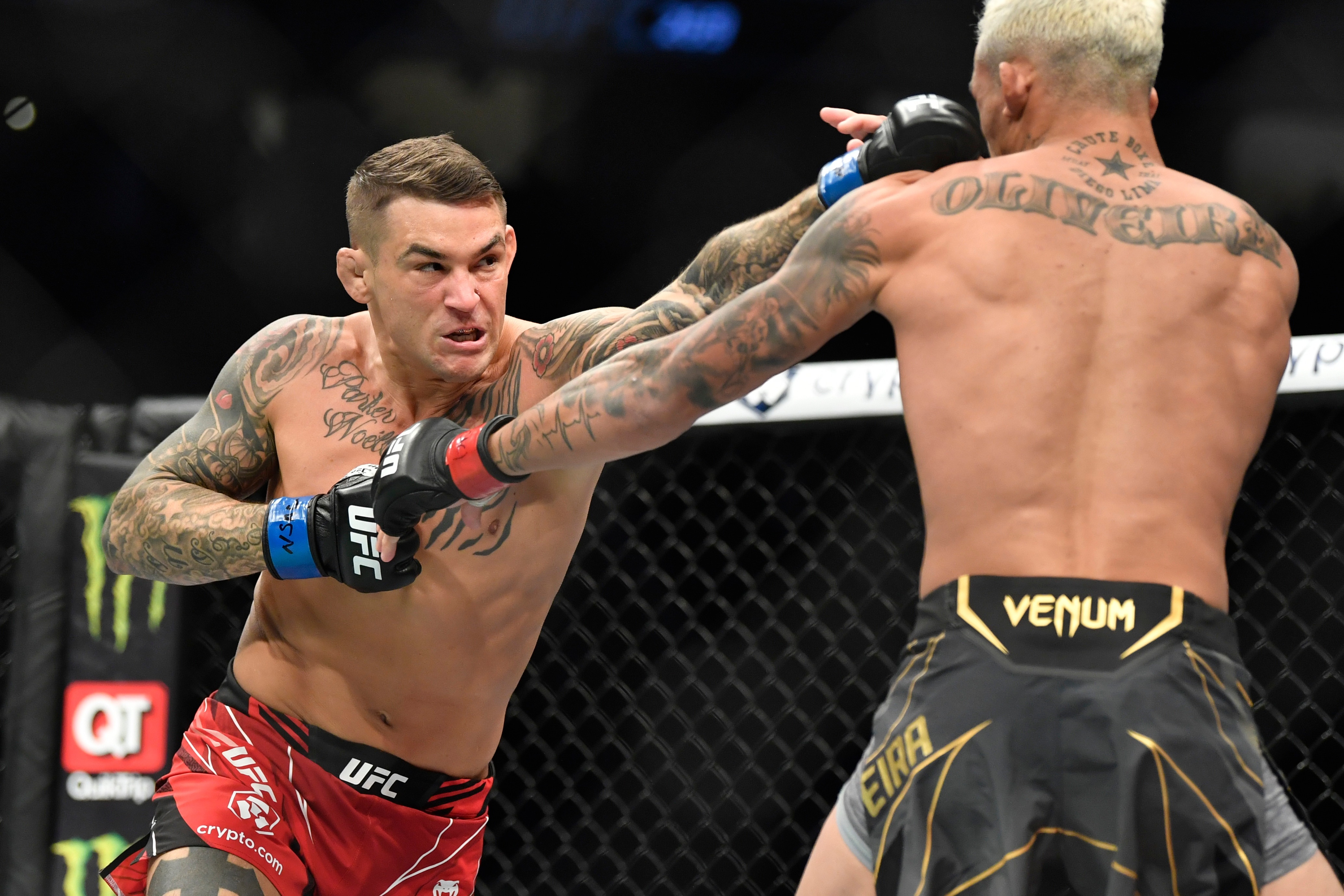 LAS VEGAS, NEVADA - DECEMBER 11:  (L-R) Dustin Poirier punches Charles Oliveira of Brazil in their lightweight championship bout during UFC 269 at T-Mobile Arena on December 11, 2021 in Las Vegas, Nevada. (Photo by Chris Unger/Zuffa LLC)