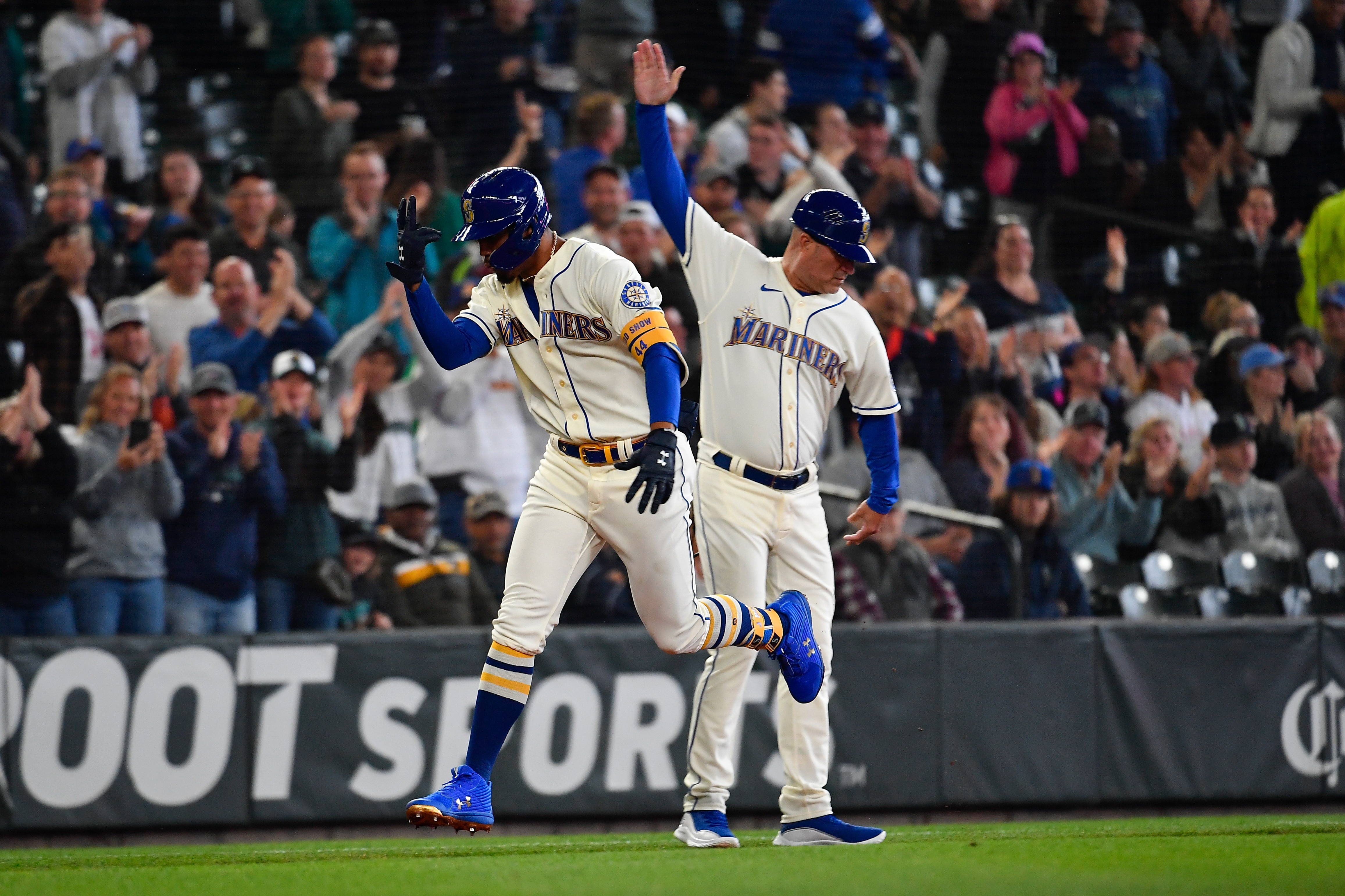 SEATTLE, WASHINGTON - JULY 03: Julio Rodriguez #44 of the Seattle Mariners celebrates with third base coach Manny Acta #14 after hitting a solo home run during the first inning against the Oakland Athletics at T-Mobile Park on July 03, 2022 in Seattle, Washington. (Photo by Alika Jenner/Getty Images)