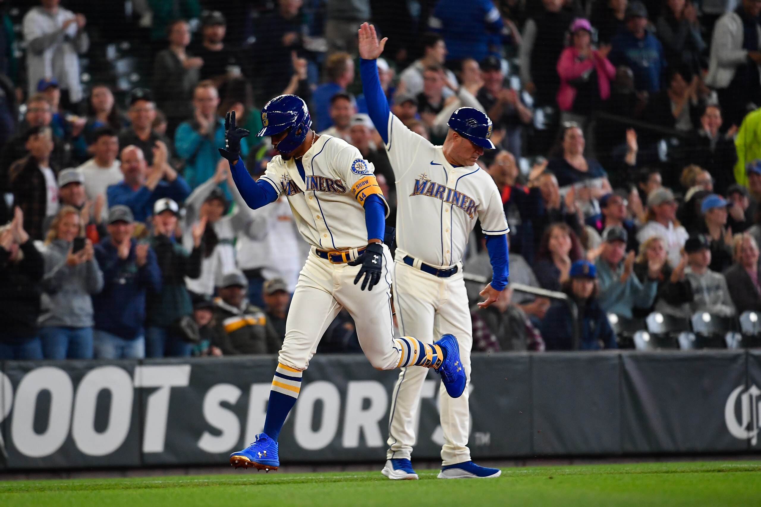 SEATTLE, WASHINGTON - JULY 03: Julio Rodriguez #44 of the Seattle Mariners celebrates with third base coach Manny Acta #14 after hitting a solo home run during the first inning against the Oakland Athletics at T-Mobile Park on July 03, 2022 in Seattle, Washington. (Photo by Alika Jenner/Getty Images)