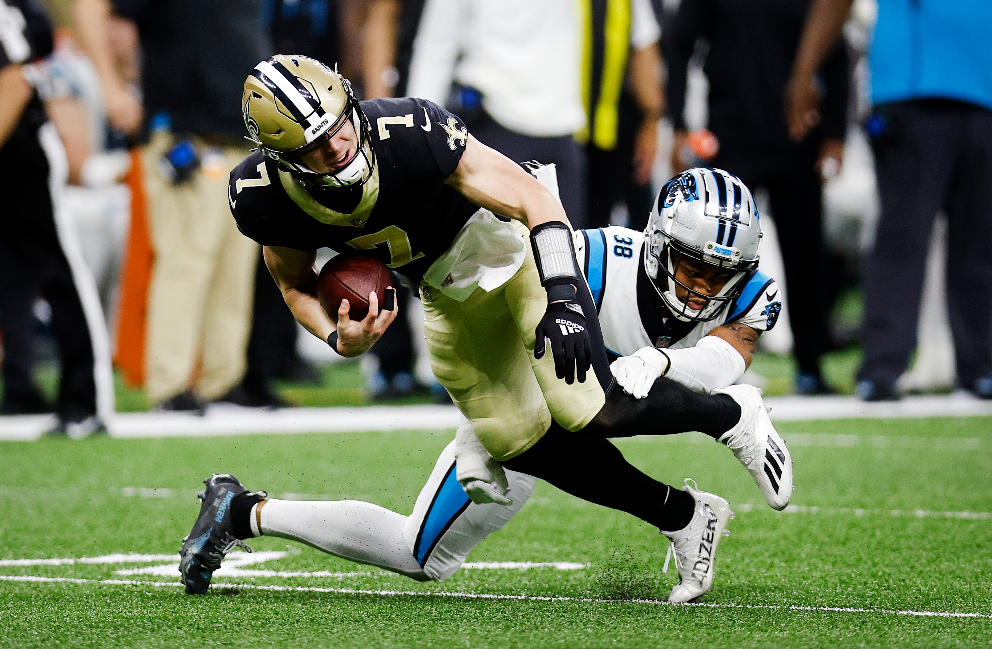 NEW ORLEANS, LOUISIANA - JANUARY 02: Myles Hartsfield #38 of the Carolina Panthers tackles Taysom Hill #7 of the New Orleans Saints in the third quarter of the game at Caesars Superdome on January 02, 2022 in New Orleans, Louisiana. (Photo by Chris Graythen/Getty Images)