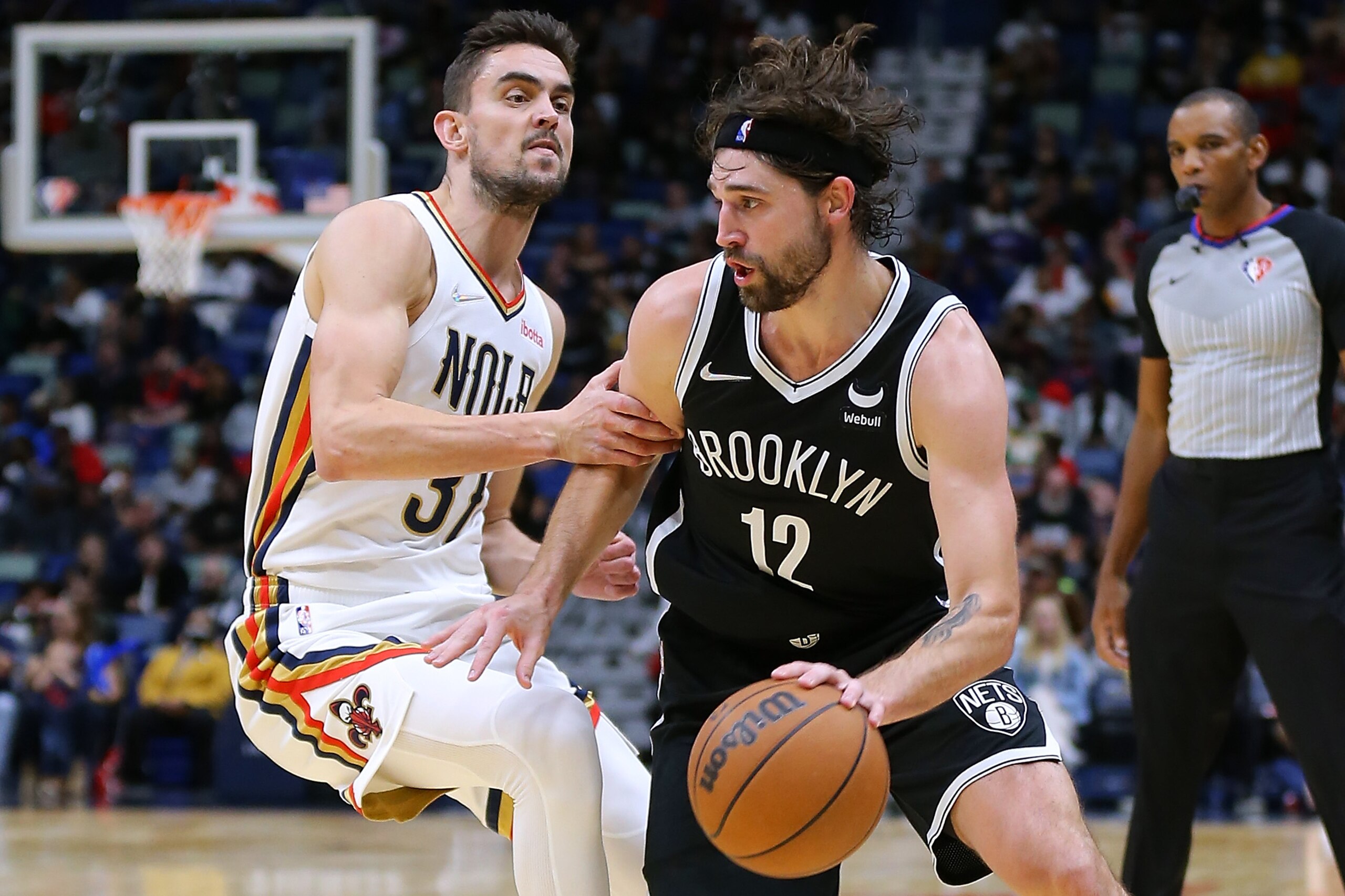 NEW ORLEANS, LOUISIANA - NOVEMBER 12: Joe Harris #12 of the Brooklyn Nets drives against Tomas Satoransky #31 of the New Orleans Pelicans during the second half at the Smoothie King Center on November 12, 2021 in New Orleans, Louisiana. NOTE TO USER: User expressly acknowledges and agrees that, by downloading and or using this Photograph, user is consenting to the terms and conditions of the Getty Images License Agreement. (Photo by Jonathan Bachman/Getty Images)