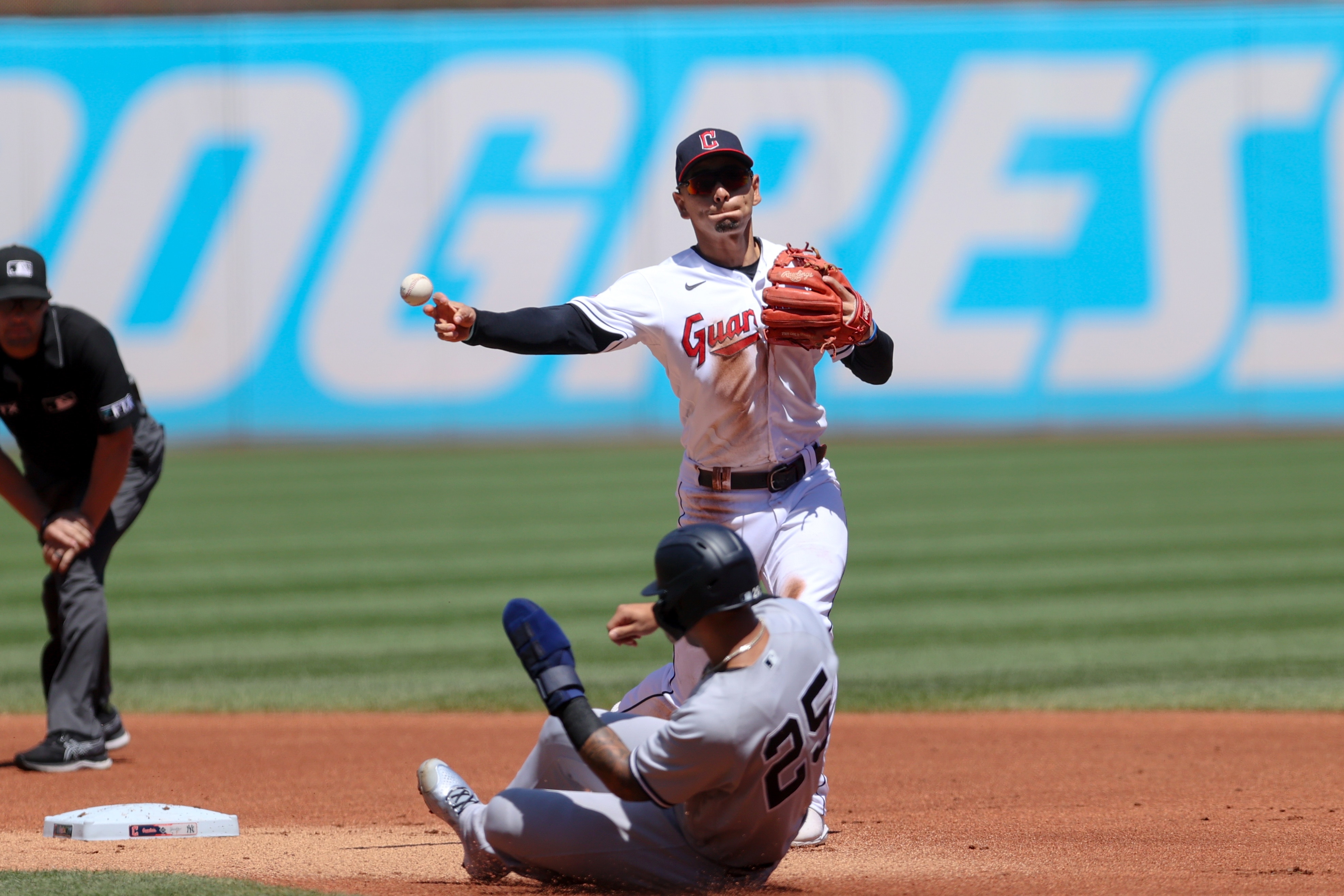 CLEVELAND, OH - JULY 02: Cleveland Guardians second baseman Andres Gimenez (0) throws to first base over a sliding New York Yankees second baseman Gleyber Torres (25) to complete a double play during the first inning of game 1 of the Major League Baseball doubleheader between the New York Yankees and Cleveland Guardians on July 2, 2022, at Progressive Field in Cleveland, OH. (Photo by Frank Jansky/Icon Sportswire via Getty Images)