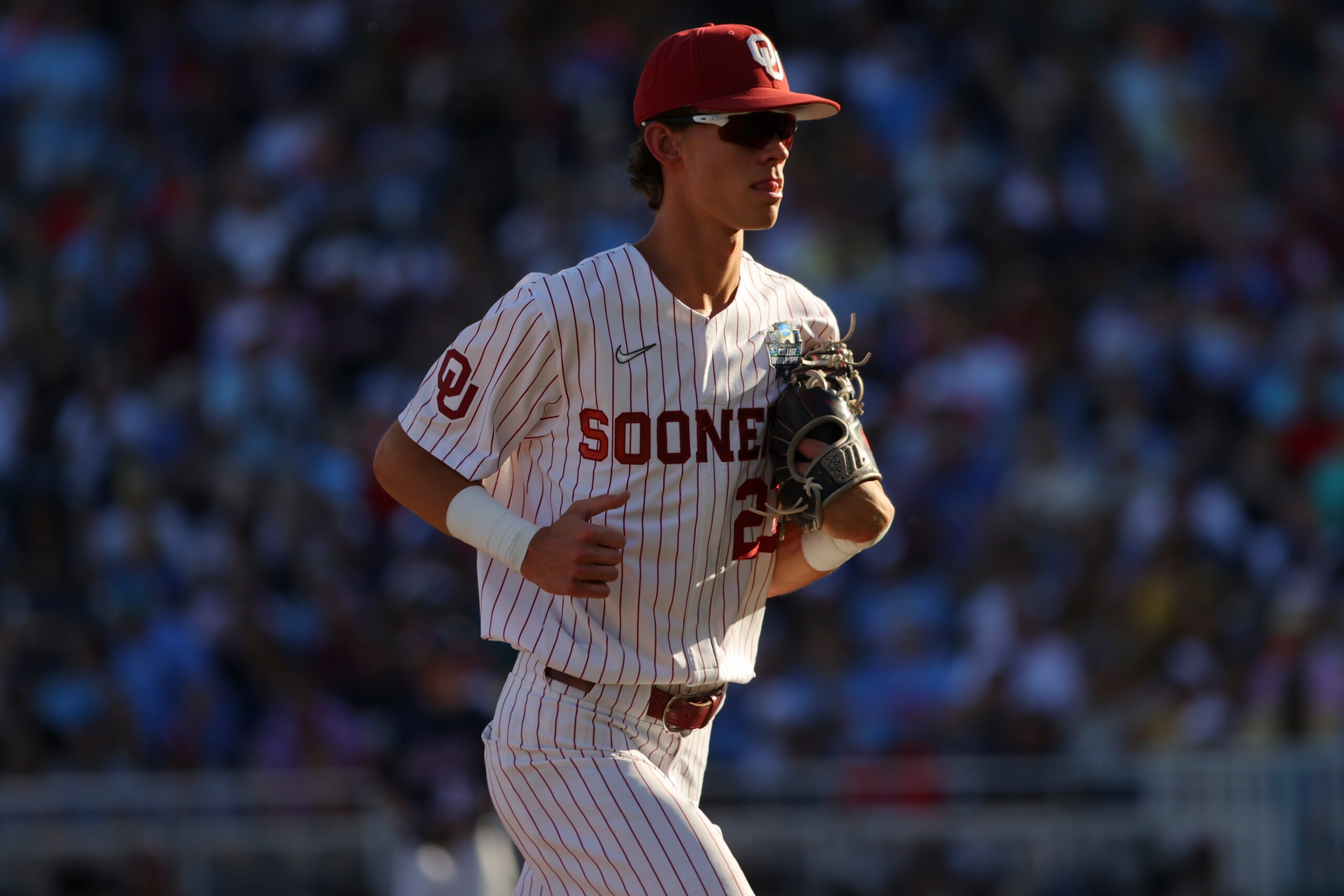OMAHA, NE - JUNE 25: Peyton Graham #20 of the Oklahoma Sooners runs forward the dugout against the Ole Miss Rebels during the Division I Men's Baseball Championship held at Charles Schwab Field Omaha on June 25, 2022 in Omaha, Nebraska. (Photo by C. Morgan Engel/NCAA Photos via Getty Images)