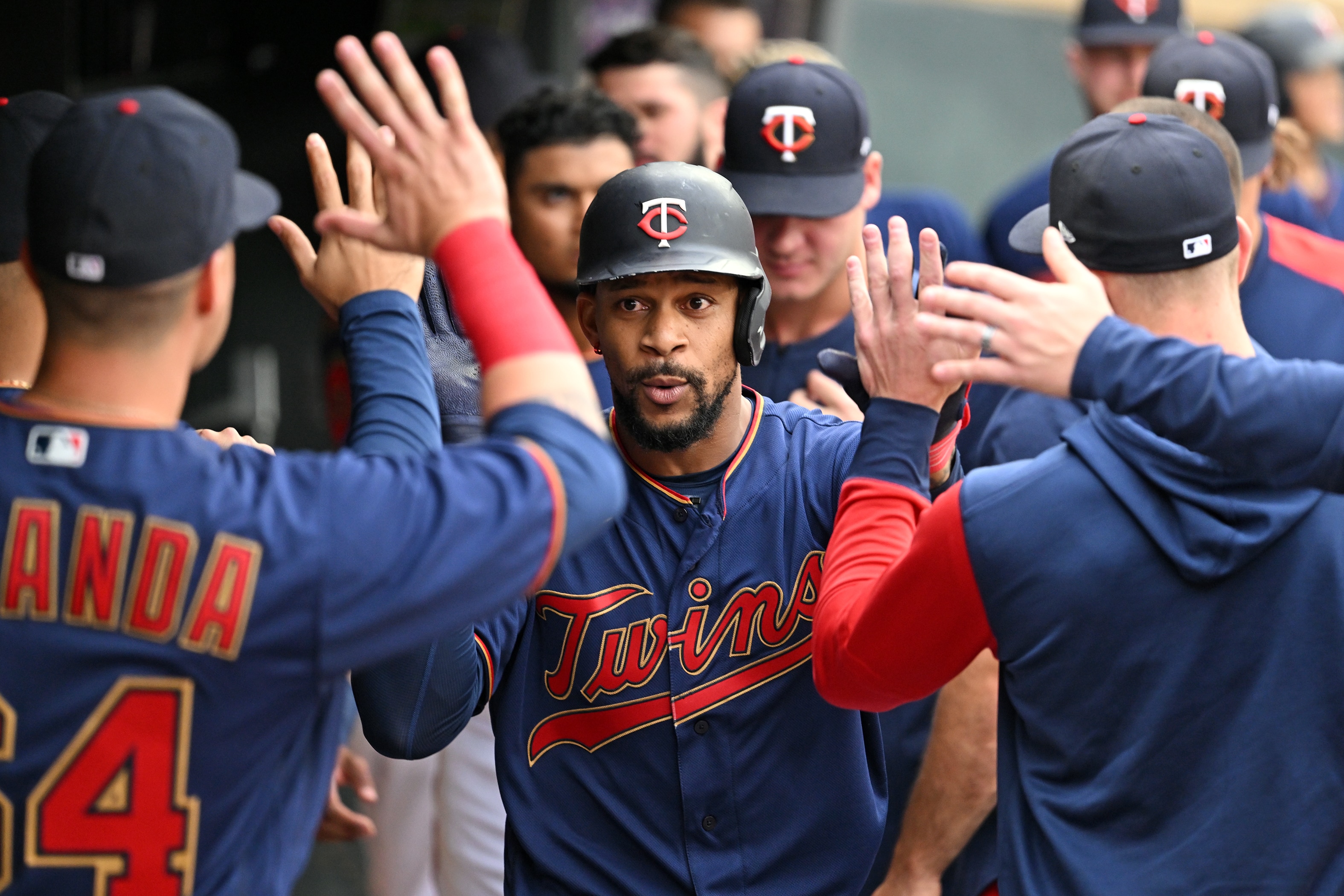 MINNEAPOLIS, MN - JUNE 10: Minnesota Twins center fielder Byron Buxton (25) high-fiving teammates in the dugout after hitting a solo home run during the first inning of a game between the Minnesota Twins and Tampa Bay Rays on June 10, 2022 at Target Field in Minneapolis, MN.(Photo by Nick Wosika/Icon Sportswire via Getty Images)