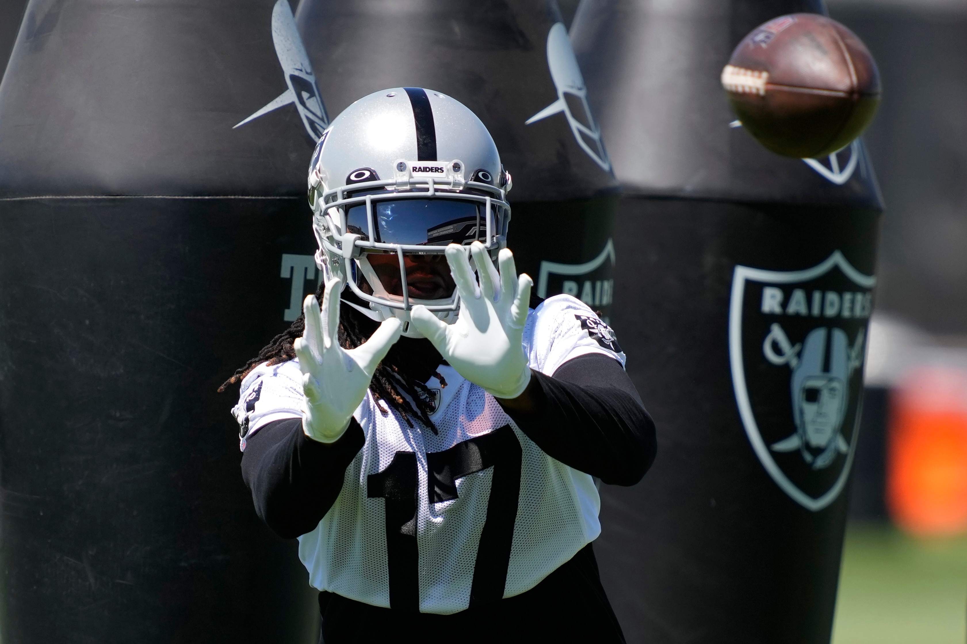 Las Vegas Raiders wide receiver Davante Adams catches a pass during practice at the NFL football team's practice facility Thursday, June 2, 2022, in Henderson, Nev. (AP Photo/John Locher)