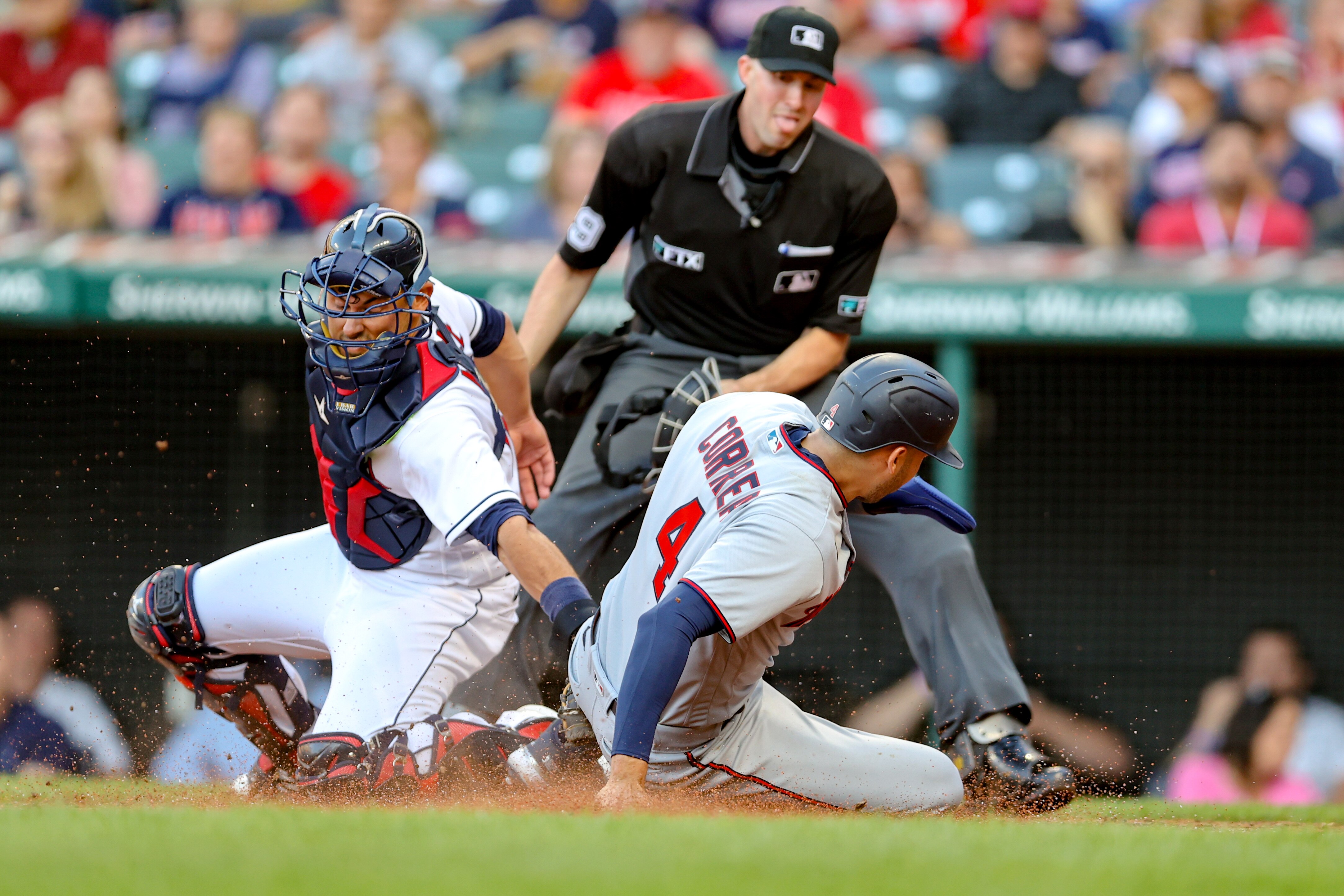 CLEVELAND, OH - JUNE 28: Minnesota Twins shortstop Carlos Correa (4) scores ahead of the tag of Cleveland Guardians catcher Luke Maile (12) during the third inning of game 2 of the Major League Baseball doubleheader between the Minnesota Twins and Cleveland Guardians on June 28, 2022, at Progressive Field in Cleveland, OH. (Photo by Frank Jansky/Icon Sportswire via Getty Images)