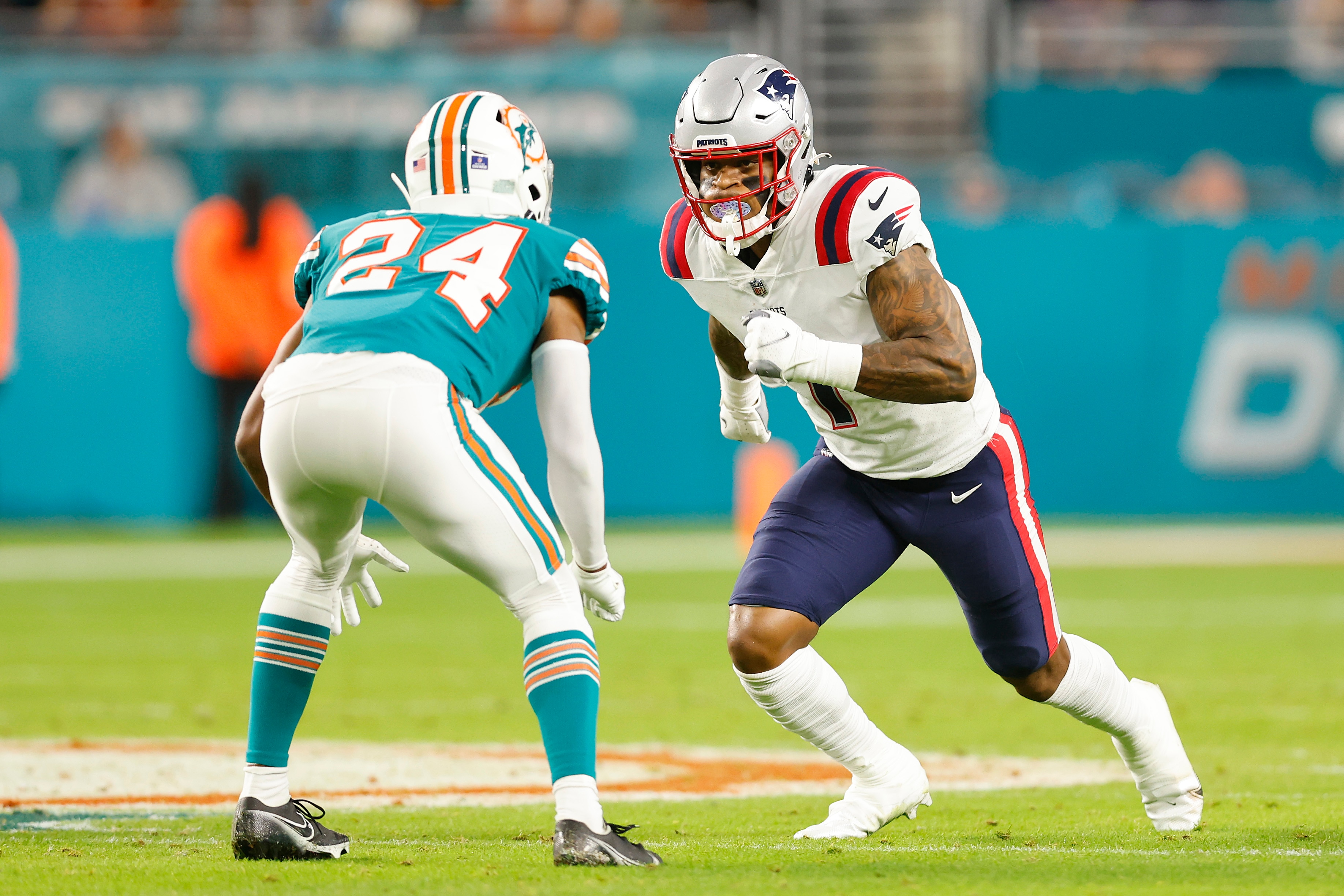 MIAMI GARDENS, FLORIDA - JANUARY 09: N'Keal Harry #1 of the New England Patriots is defended by Byron Jones #24 of the Miami Dolphins at Hard Rock Stadium on January 09, 2022 in Miami Gardens, Florida. (Photo by Michael Reaves/Getty Images)