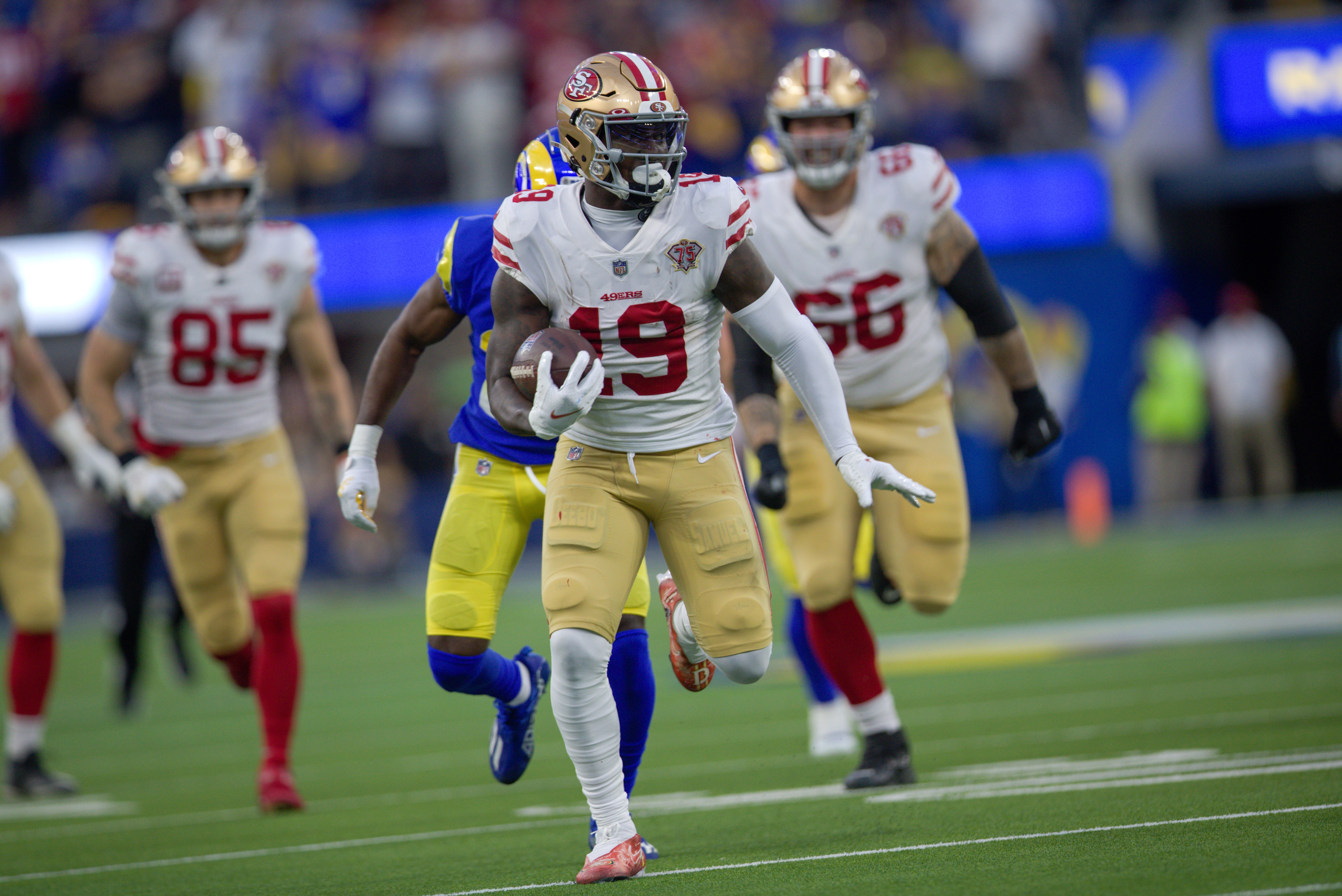 INGLEWOOD, CA - JANUARY 30: Deebo Samuel #19 of the San Francisco 49ers heads to the end zone on a 44-yard touchdown catch during the game against the Los Angeles Rams at SoFi Stadium on January 30, 2022 in Inglewood, California. The Rams defeated the 49ers 20-17. (Photo by Michael Zagaris/San Francisco 49ers/Getty Images)