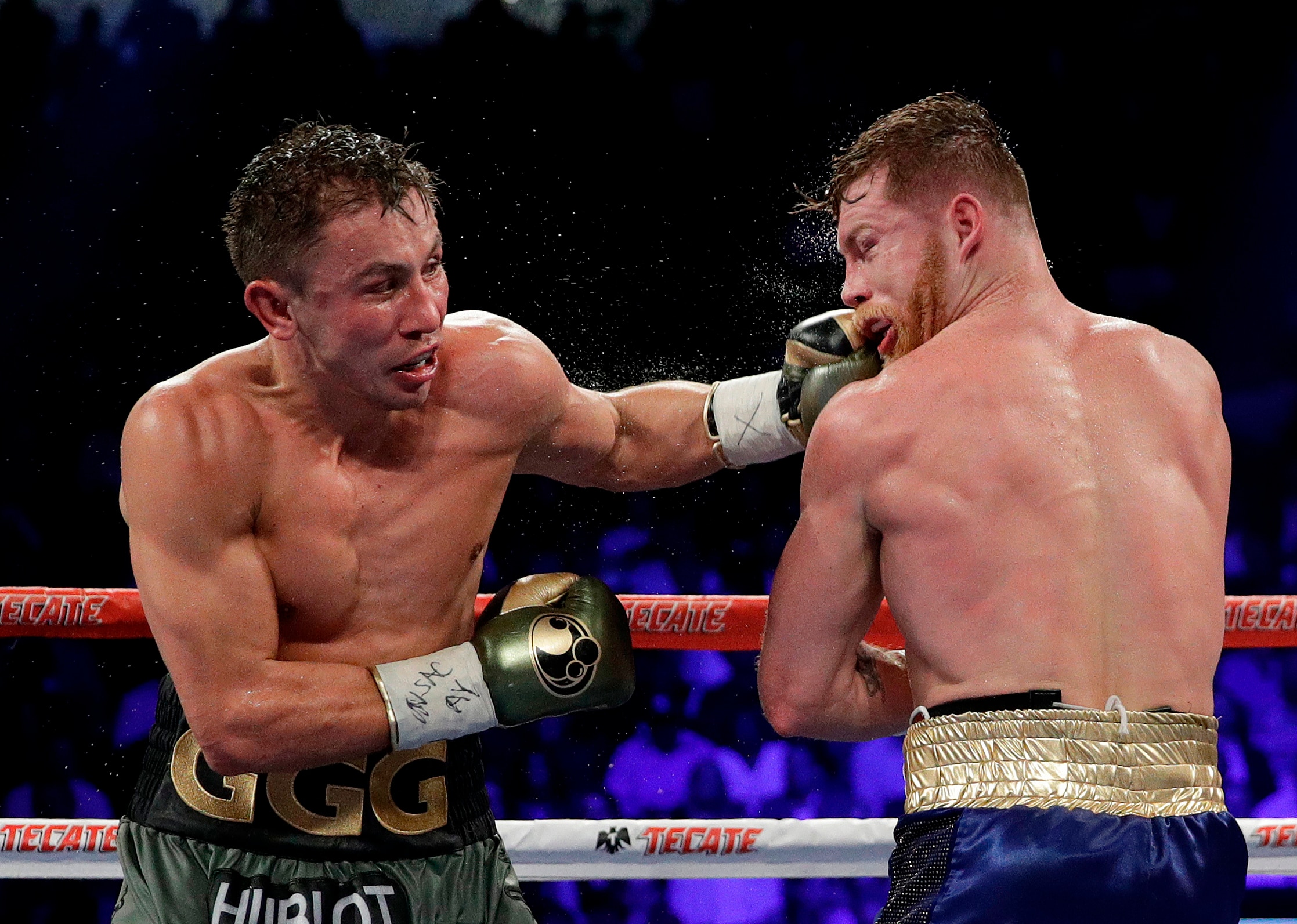 FILE - In this Sept. 17, 2017 file photo shows Gennady Golovkin, left, connects with a left to Canelo Alvarez during a middleweight title fight in Las Vegas. Golovkin is growing frustrated with boxing's sanctioning bodies while he struggles to find a replacement opponent for Canelo Alvarez on May 5. The unbeaten middleweight champion's rematch with Alvarez in Las Vegas fell through after the Mexican star failed a doping test in February and finally withdrew from the bout last week.(AP Photo/John Locher, File)