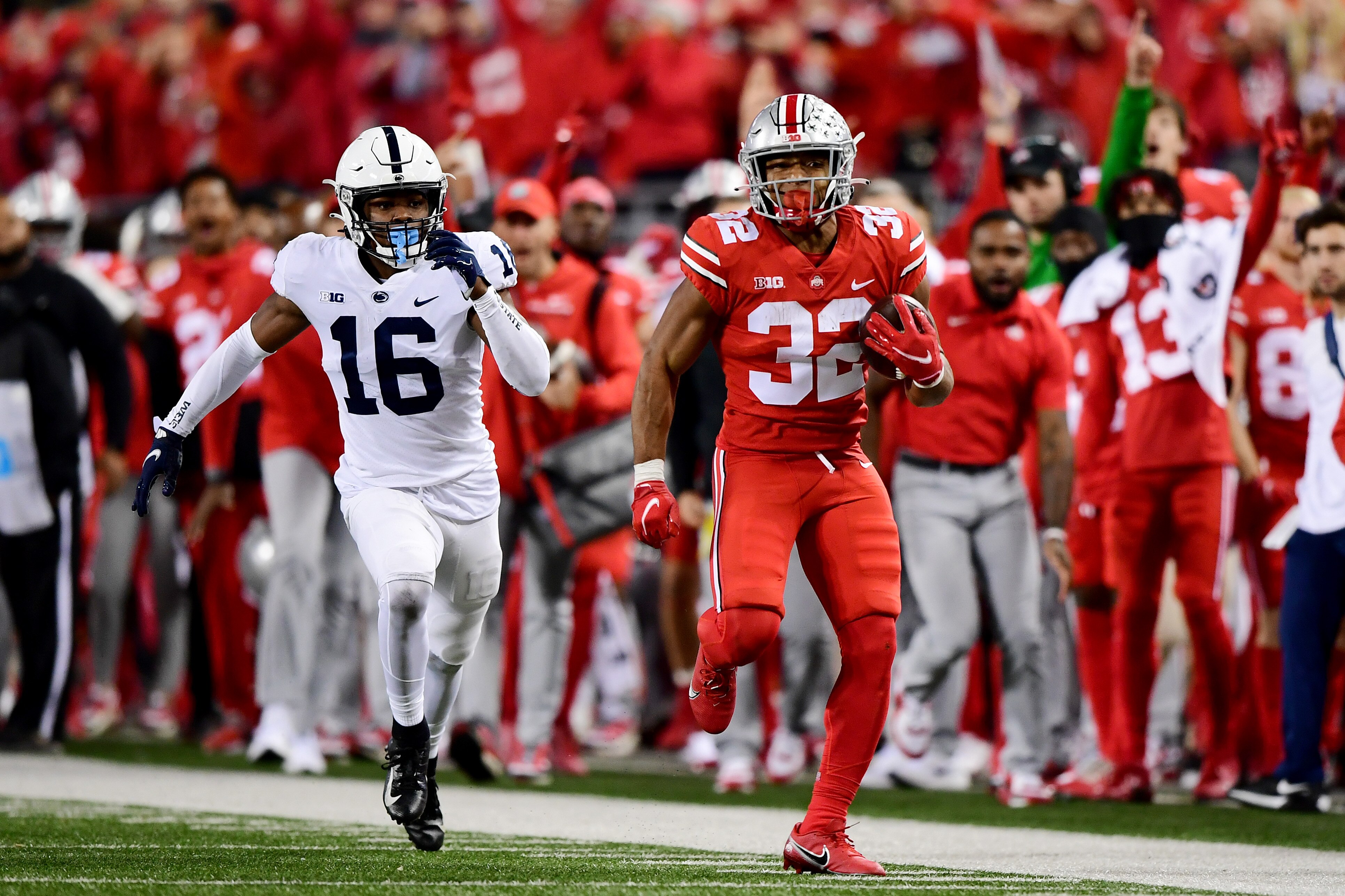 COLUMBUS, OHIO - OCTOBER 30: TreVeyon Henderson #32 of the Ohio State Buckeyes runs the ball past Ji'Ayir Brown #16 of the Penn State Nittany Lions during the second half of their game at Ohio Stadium on October 30, 2021 in Columbus, Ohio. (Photo by Emilee Chinn/Getty Images)