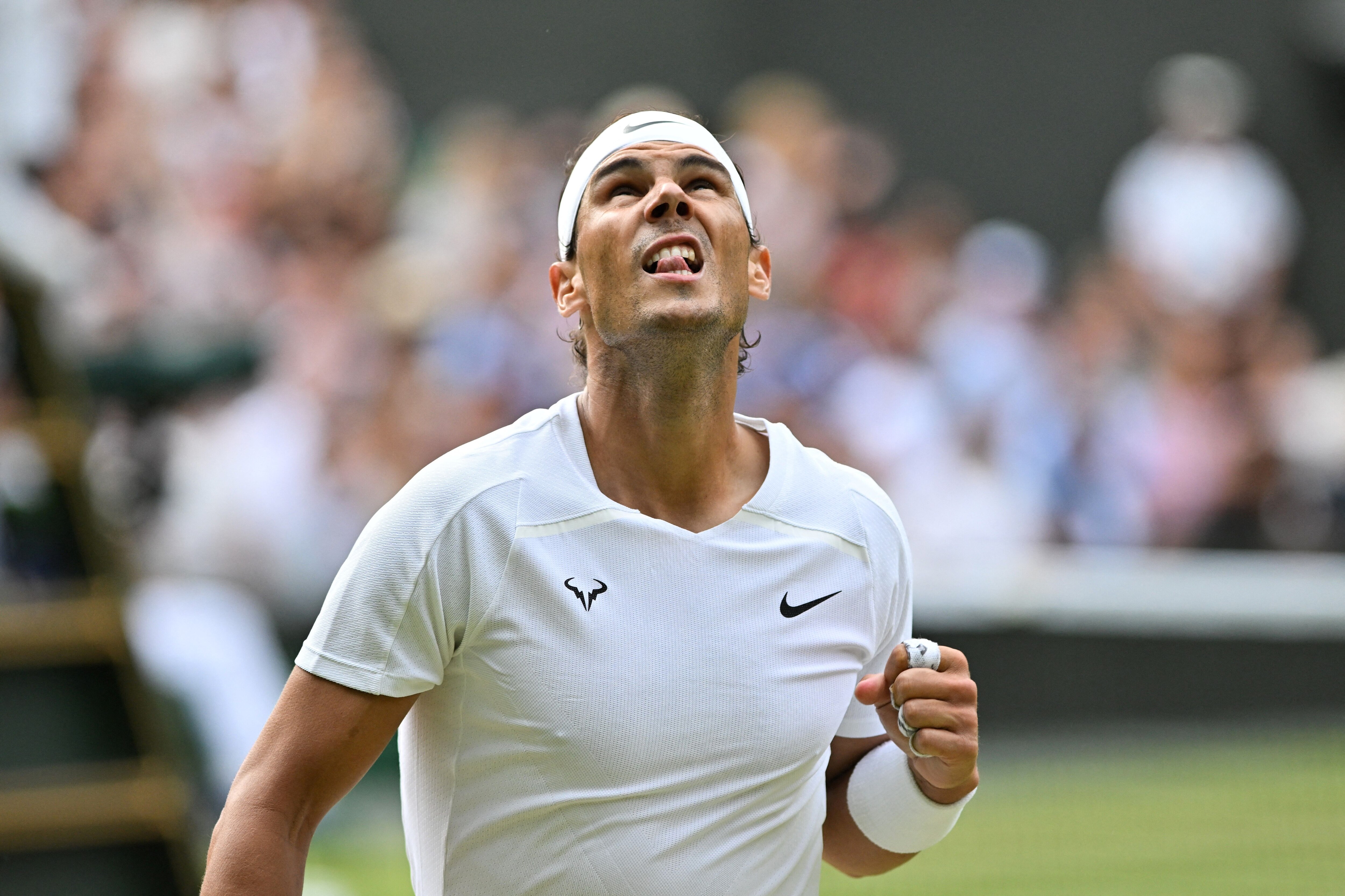 Spain's Rafael Nadal celebrates winning a point against US player Taylor Fritz during their men's singles quarter final tennis match on the tenth day of the 2022 Wimbledon Championships at The All England Tennis Club in Wimbledon, southwest London, on July 6, 2022. - RESTRICTED TO EDITORIAL USE (Photo by Glyn KIRK / AFP) / RESTRICTED TO EDITORIAL USE (Photo by GLYN KIRK/AFP via Getty Images)