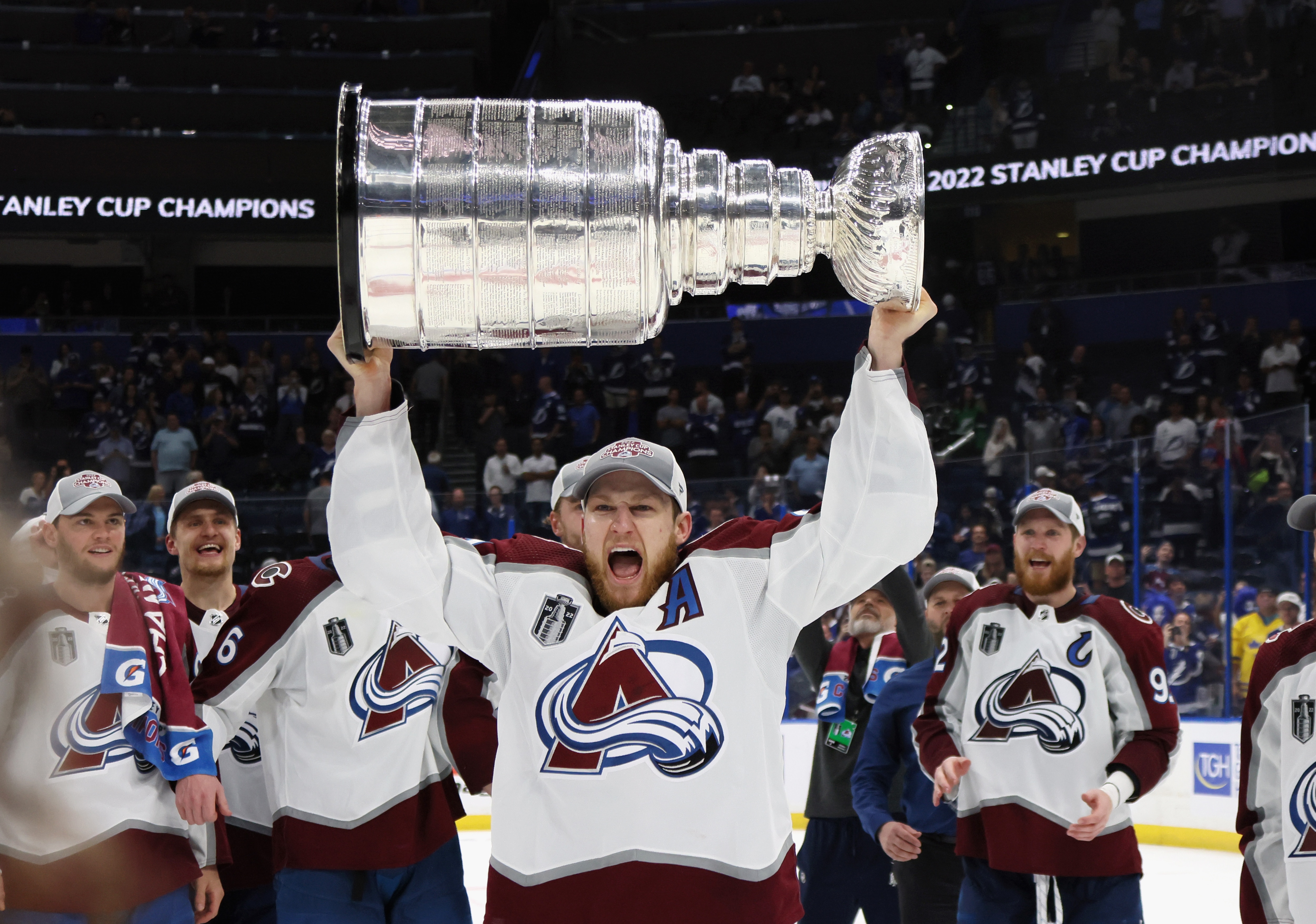 TAMPA, FLORIDA - JUNE 26: Nathan MacKinnon #29 of the Colorado Avalanche carries the Stanley Cup following the series winning victory over the Tampa Bay Lightning in Game Six of the 2022 NHL Stanley Cup Final at Amalie Arena on June 26, 2022 in Tampa, Florida. (Photo by Bruce Bennett/Getty Images)