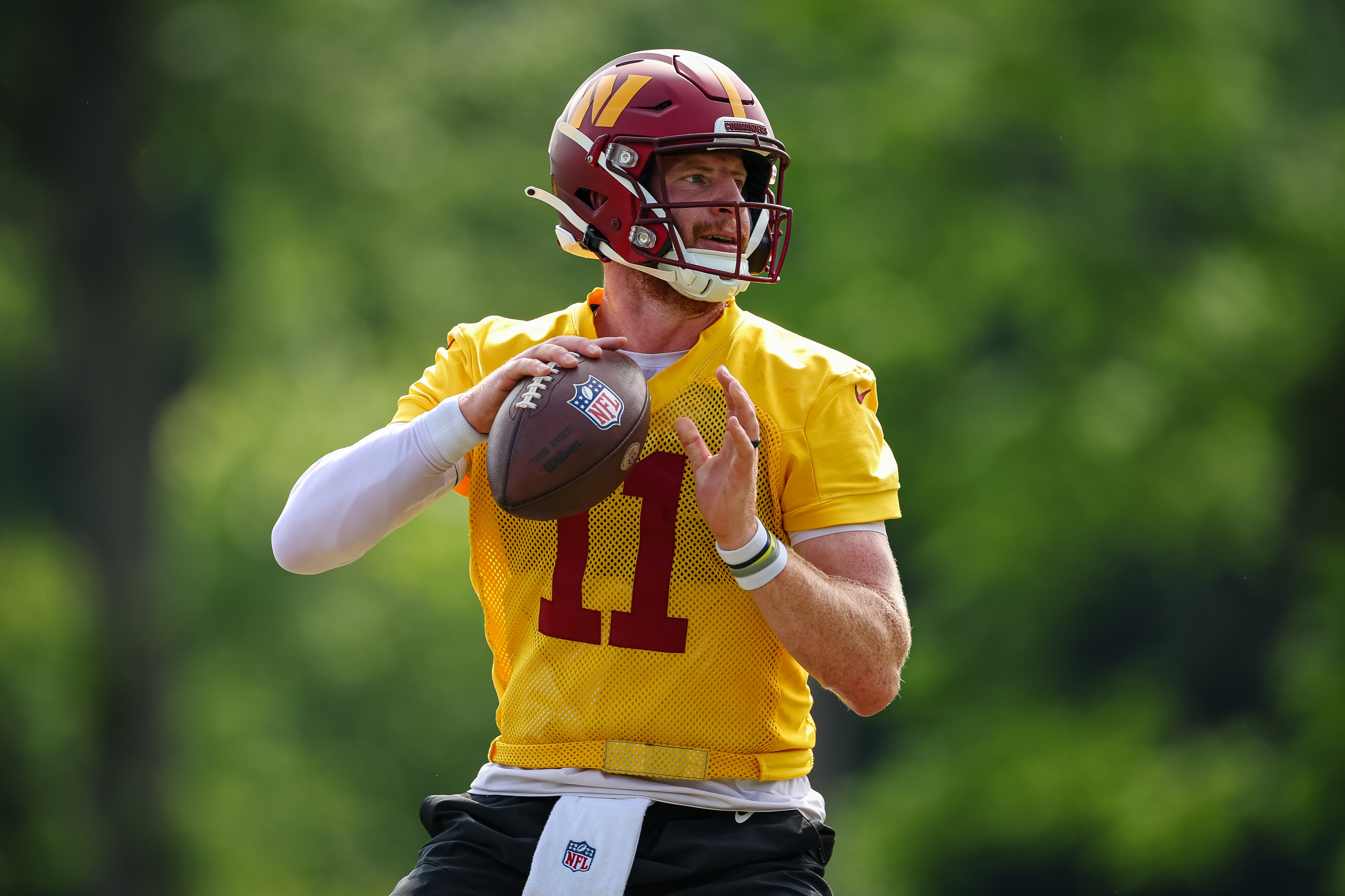 ASHBURN, VA - JUNE 16: Carson Wentz #11 of the Washington Commanders looks to pass during the organized team activity at INOVA Sports Performance Center on June 16, 2022 in Ashburn, Virginia. (Photo by Scott Taetsch/Getty Images)