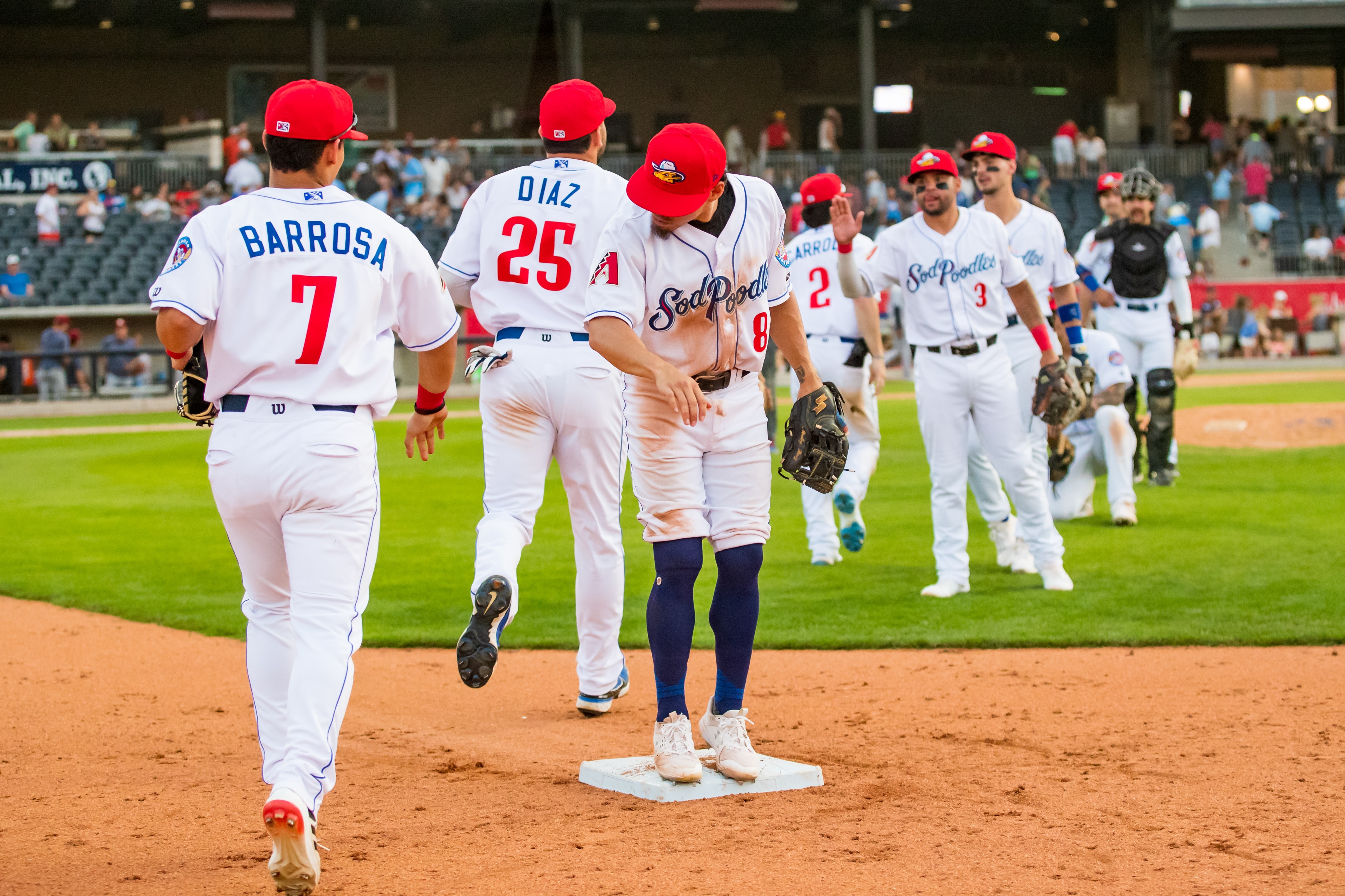AMARILLO, TEXAS - JUNE 12: Outfielder Jorge Barrosa #7 and infielder Jancarlos Cintron #8 of the Amarillo Sod Poodles high five after the game against the Frisco RoughRiders at HODGETOWN Stadium on June 12, 2022 in Amarillo, Texas. (Photo by John E. Moore III/Getty Images)