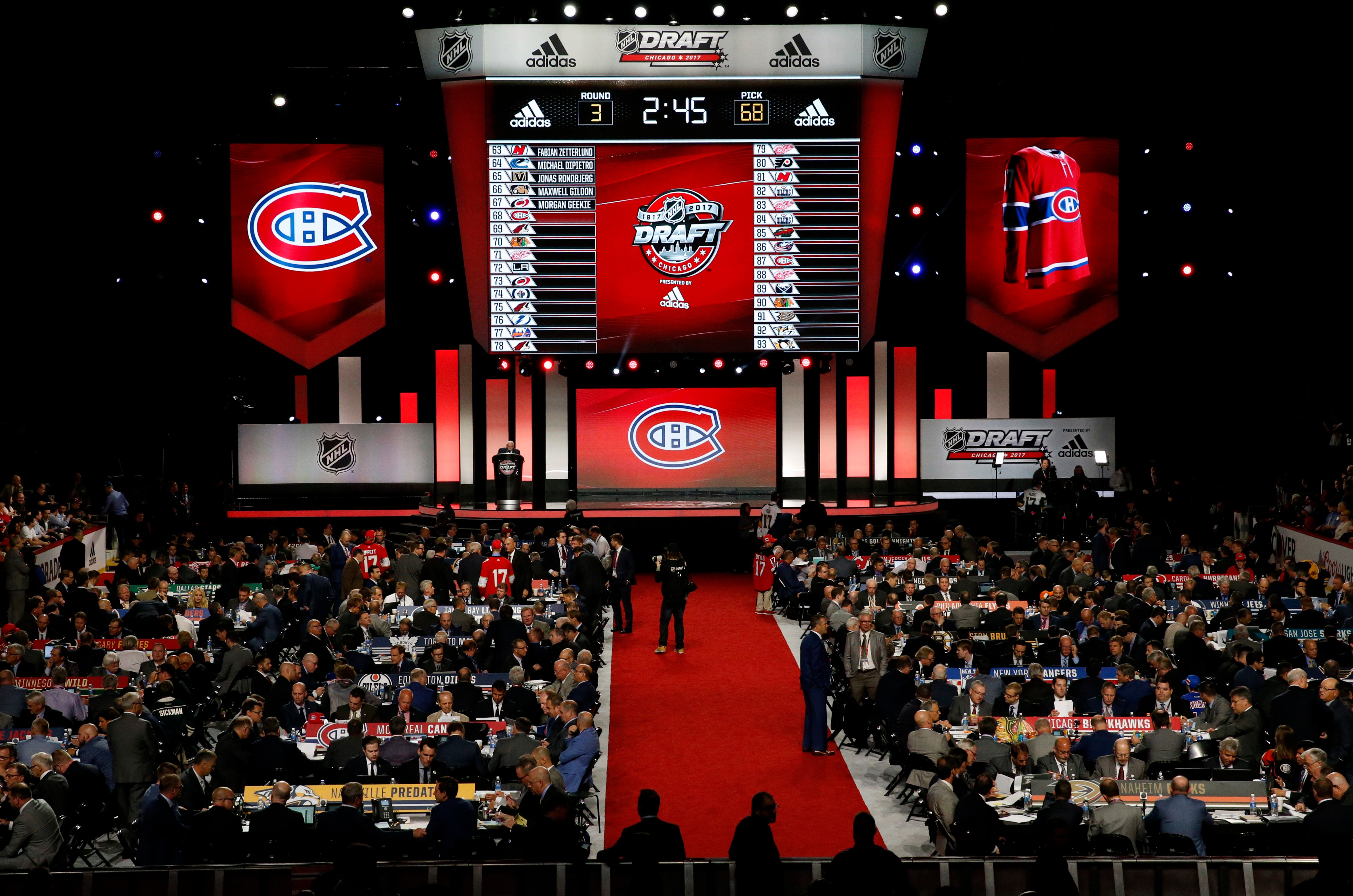 Montreal Canadiens representatives work on their third round select of the NHL hockey draft, Saturday, June 24, 2017, in Chicago. (AP Photo/Nam Y. Huh)