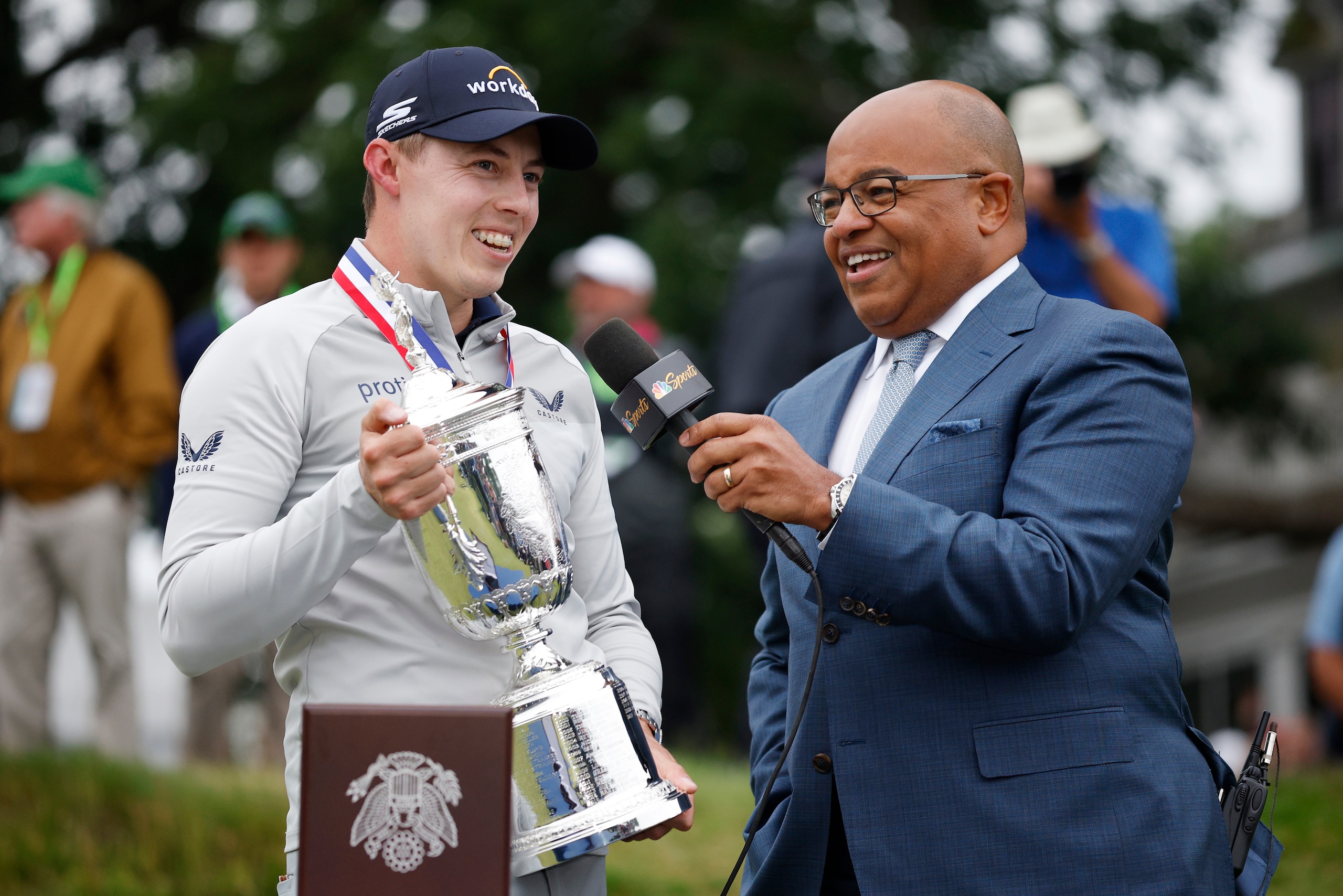 BROOKLINE, MASSACHUSETTS - JUNE 19: (L-R) Matt Fitzpatrick of England speaks with sportscaster Mike Tirico after being awarded the U.S. Open Championship trophy in honor of his victory during the final round of the 122nd U.S. Open Championship at The Country Club on June 19, 2022 in Brookline, Massachusetts. (Photo by Jared C. Tilton/Getty Images)