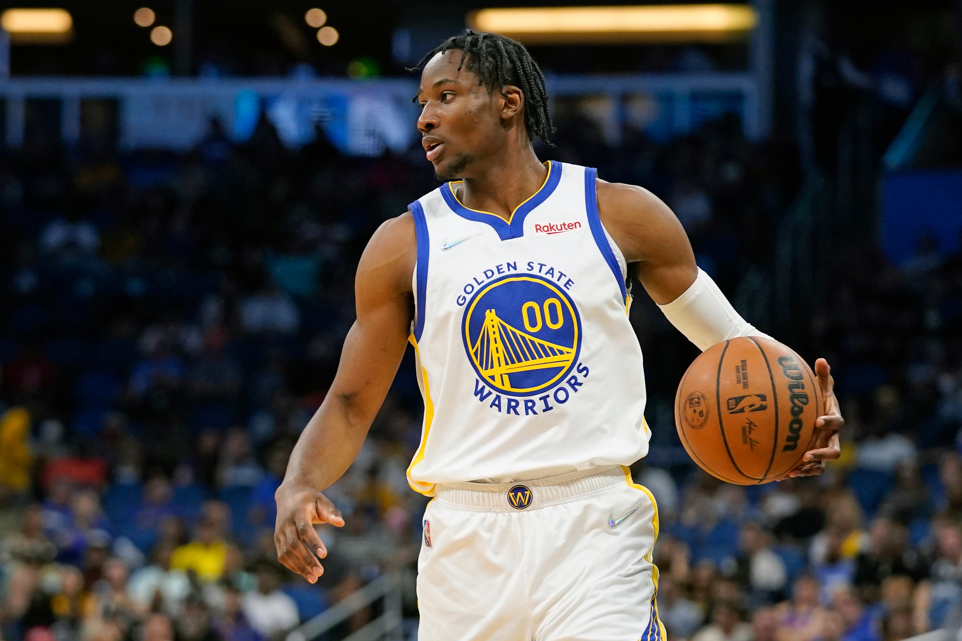 Golden State Warriors forward Jonathan Kuminga (00) moves the ball against the Orlando Magic during the first half of an NBA basketball game, Tuesday, March 22, 2022, in Orlando, Fla. (AP Photo/John Raoux)